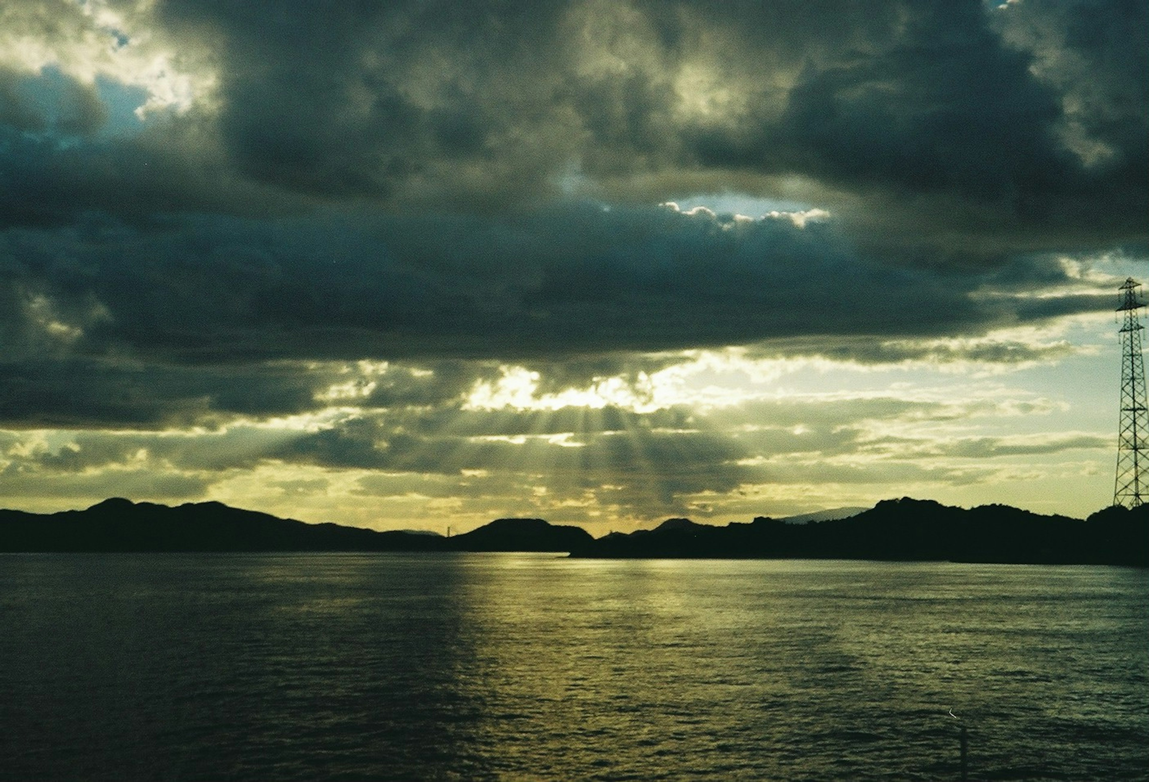 Paisaje marítimo dramático con nubes oscuras y luz que se filtra