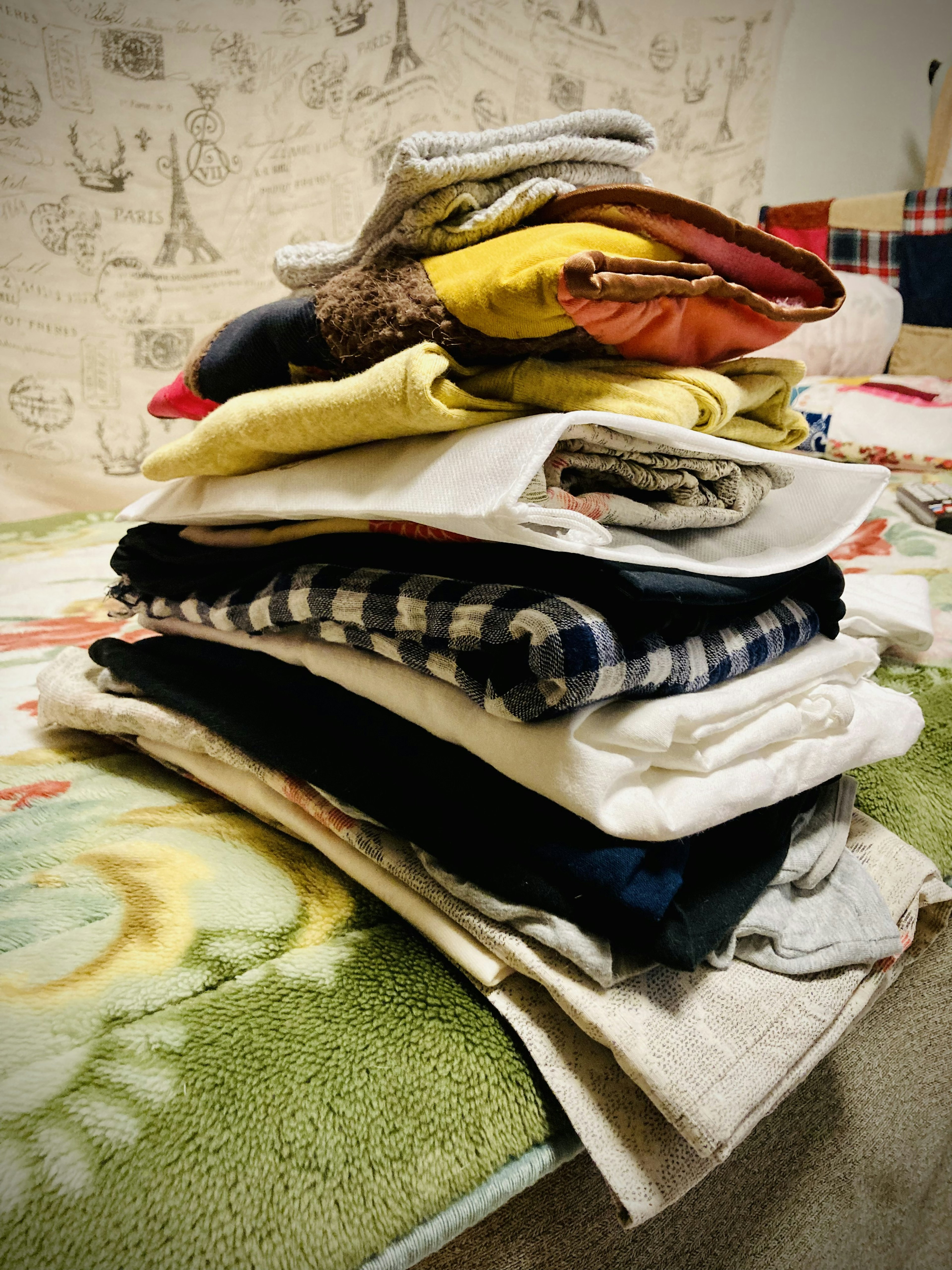 A neatly stacked pile of colorful folded clothes