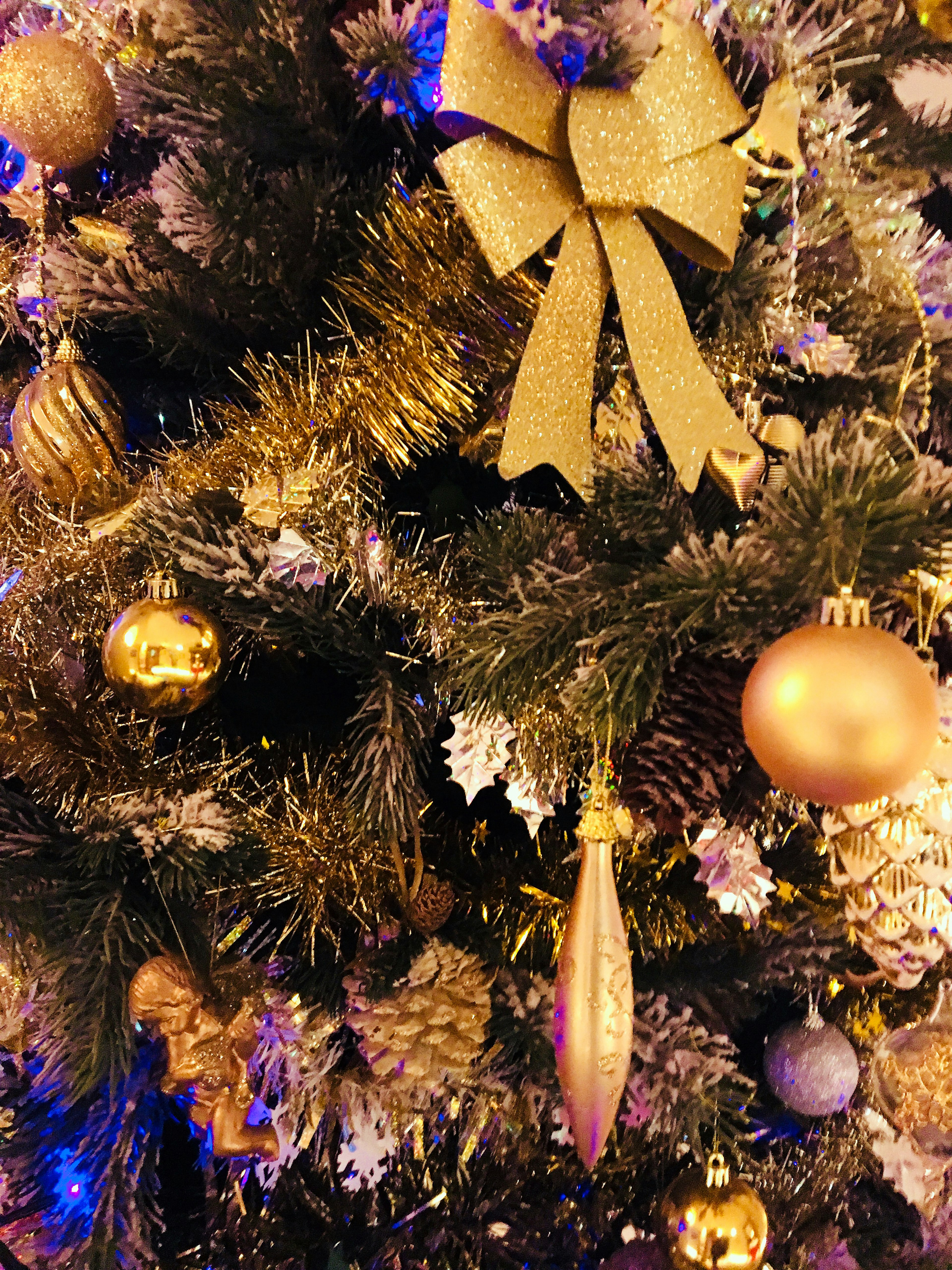 Arbre de Noël décoré avec un nœud doré et des ornements