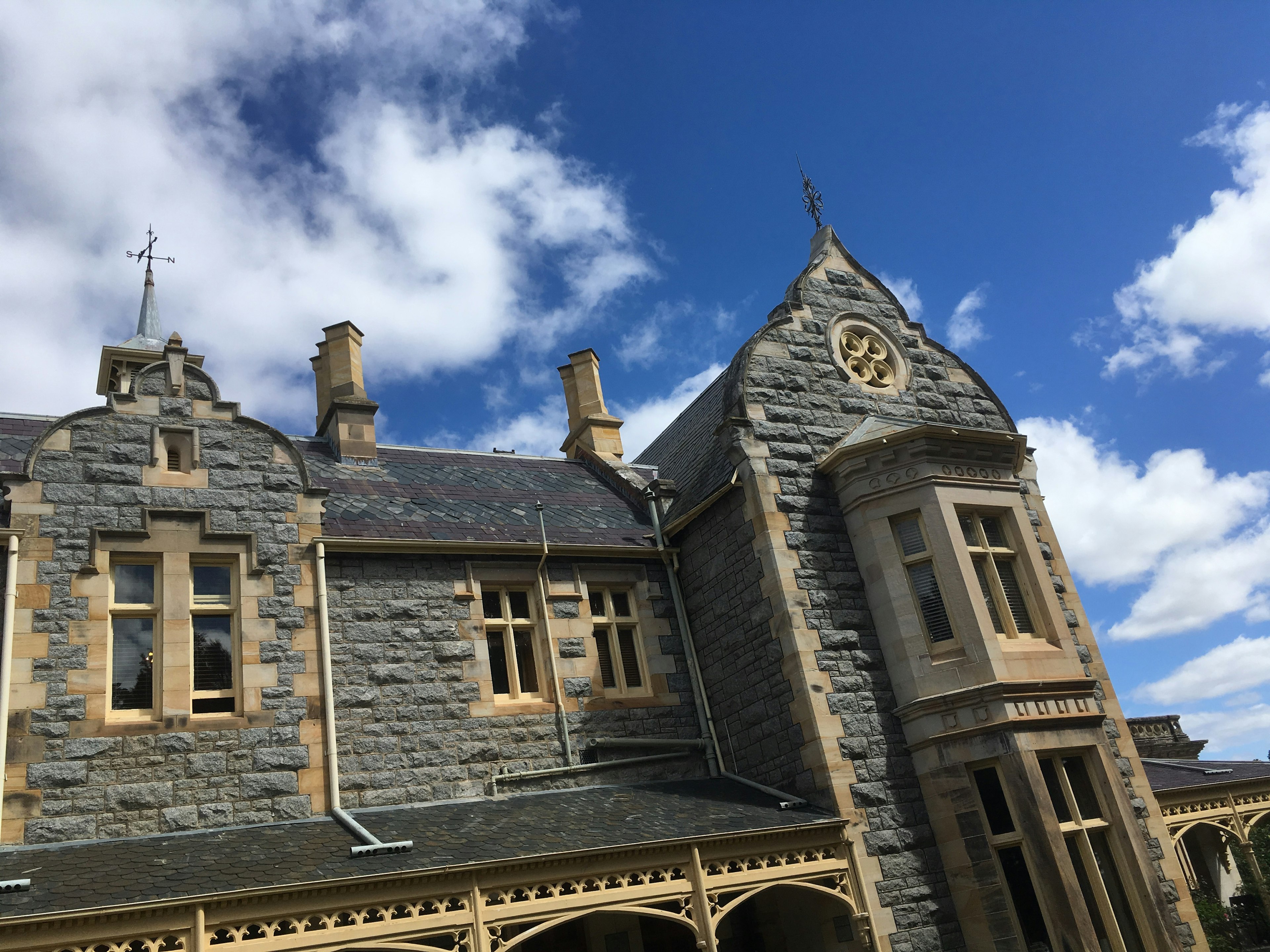 Victorian stone building with intricate architecture and blue sky