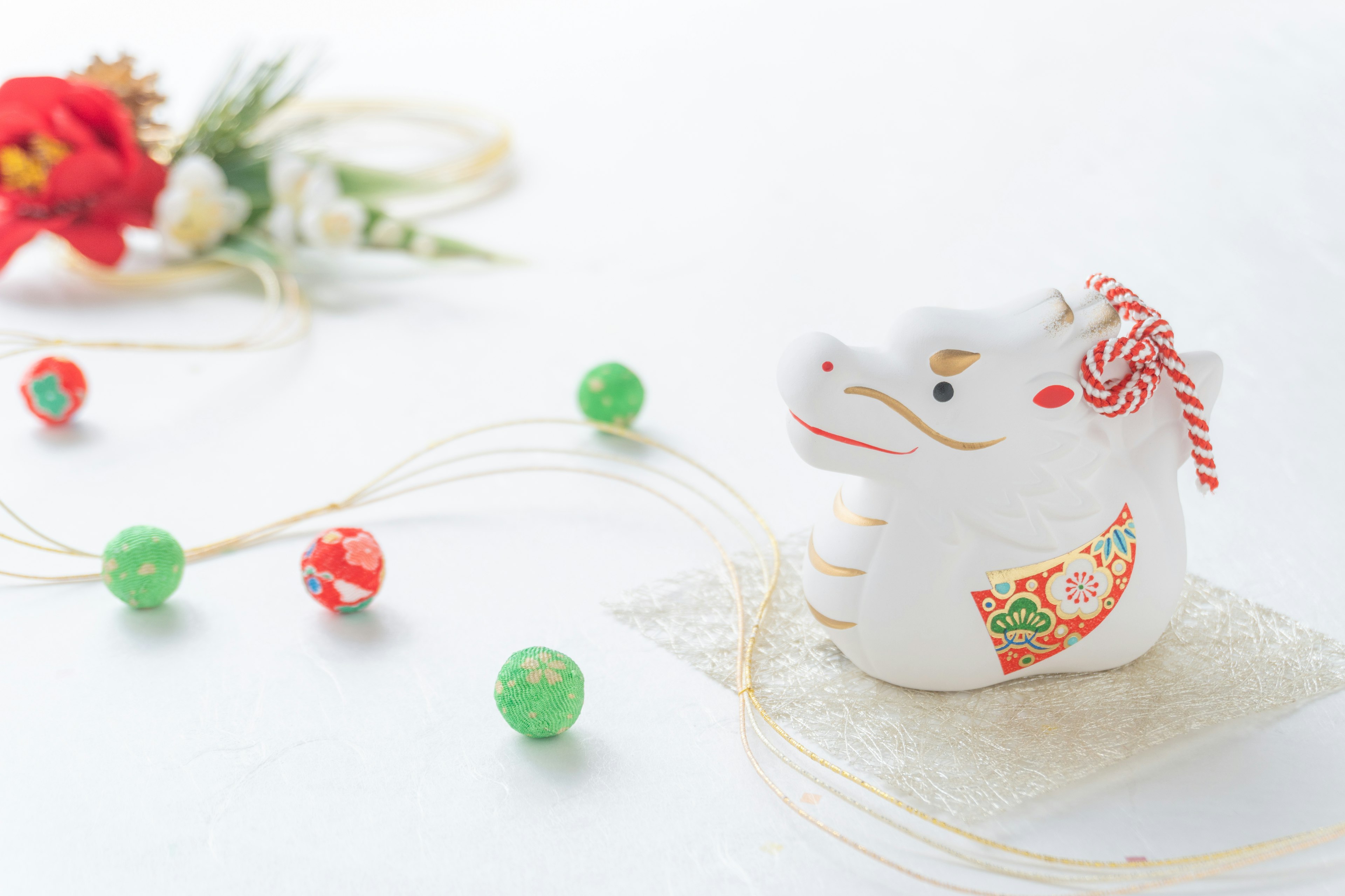 White cow figurine with colorful decorations in a serene setting