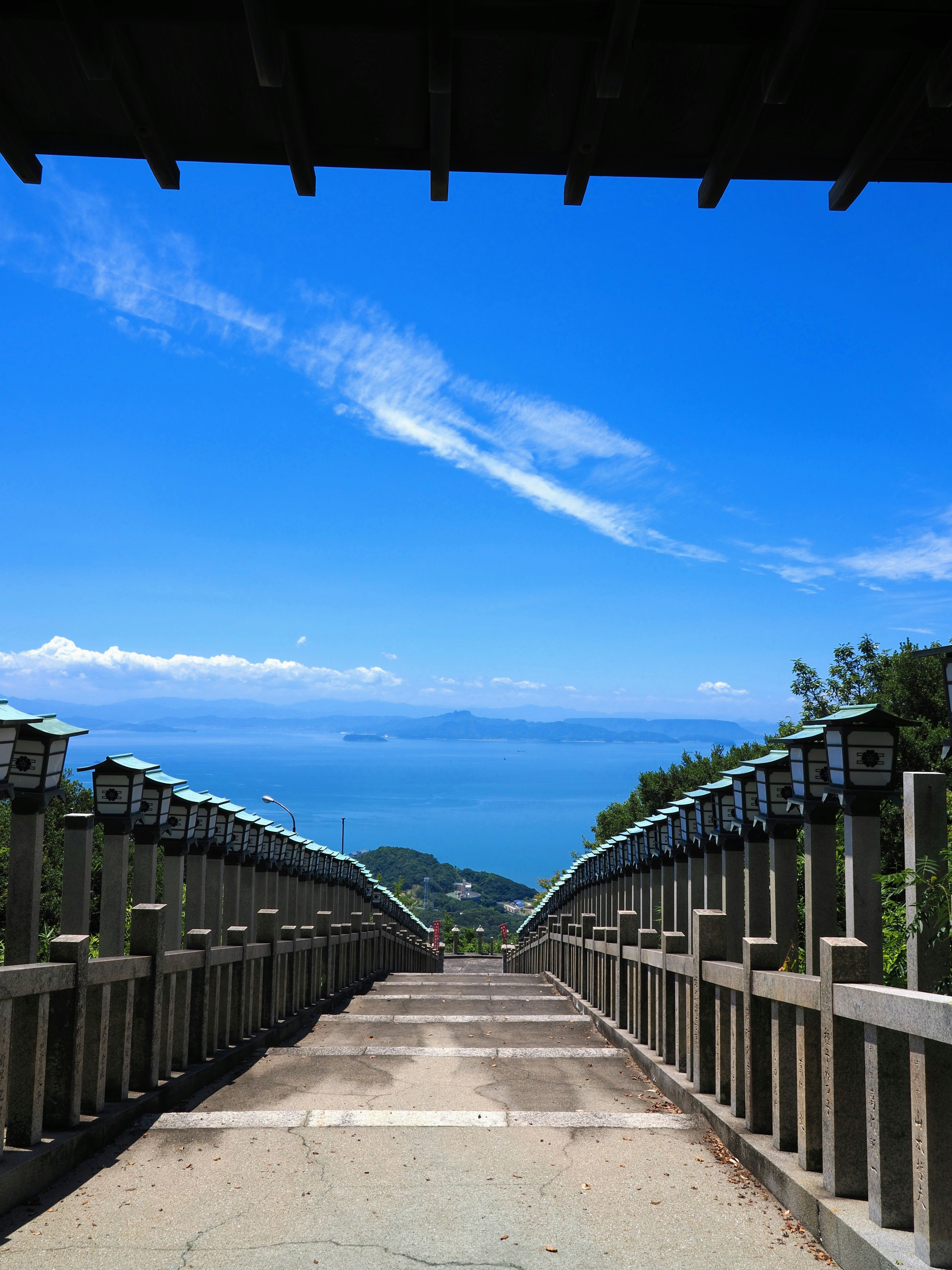 Stairway leading down to the ocean under a blue sky