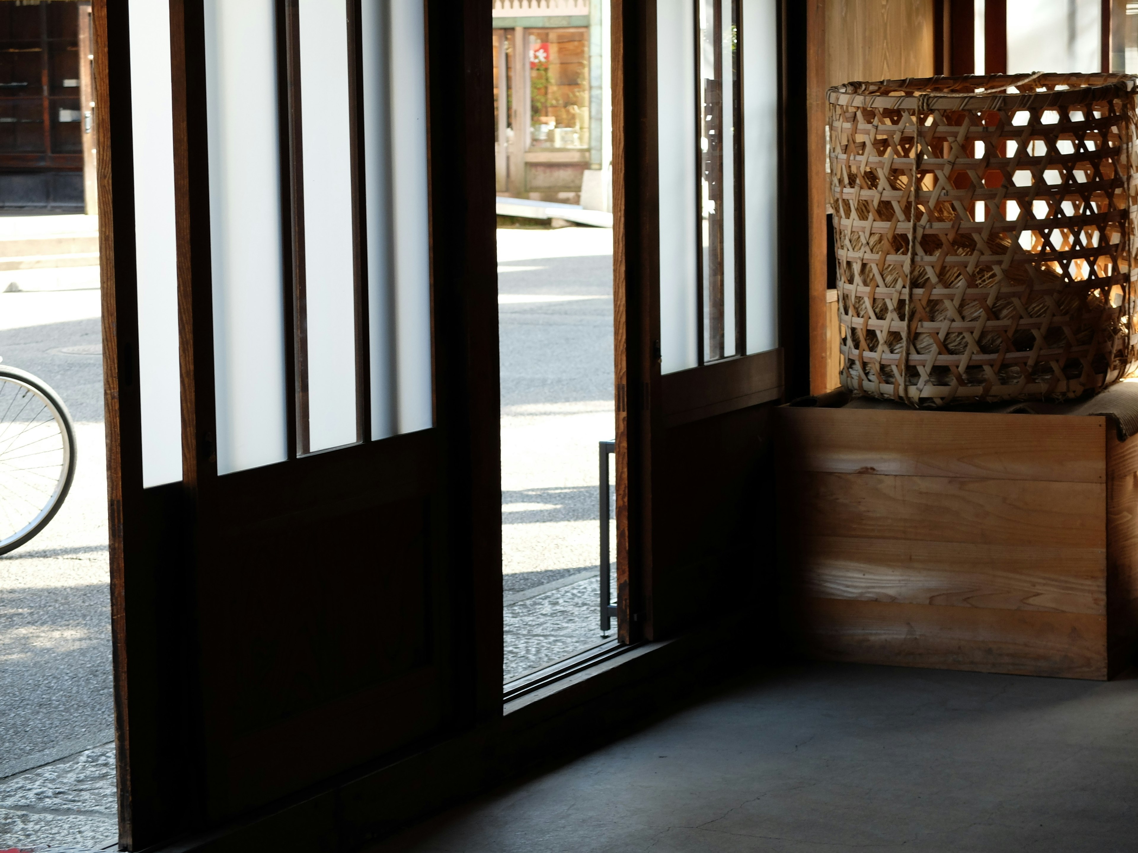 Corner of a room featuring wooden doors and traditional Japanese decor