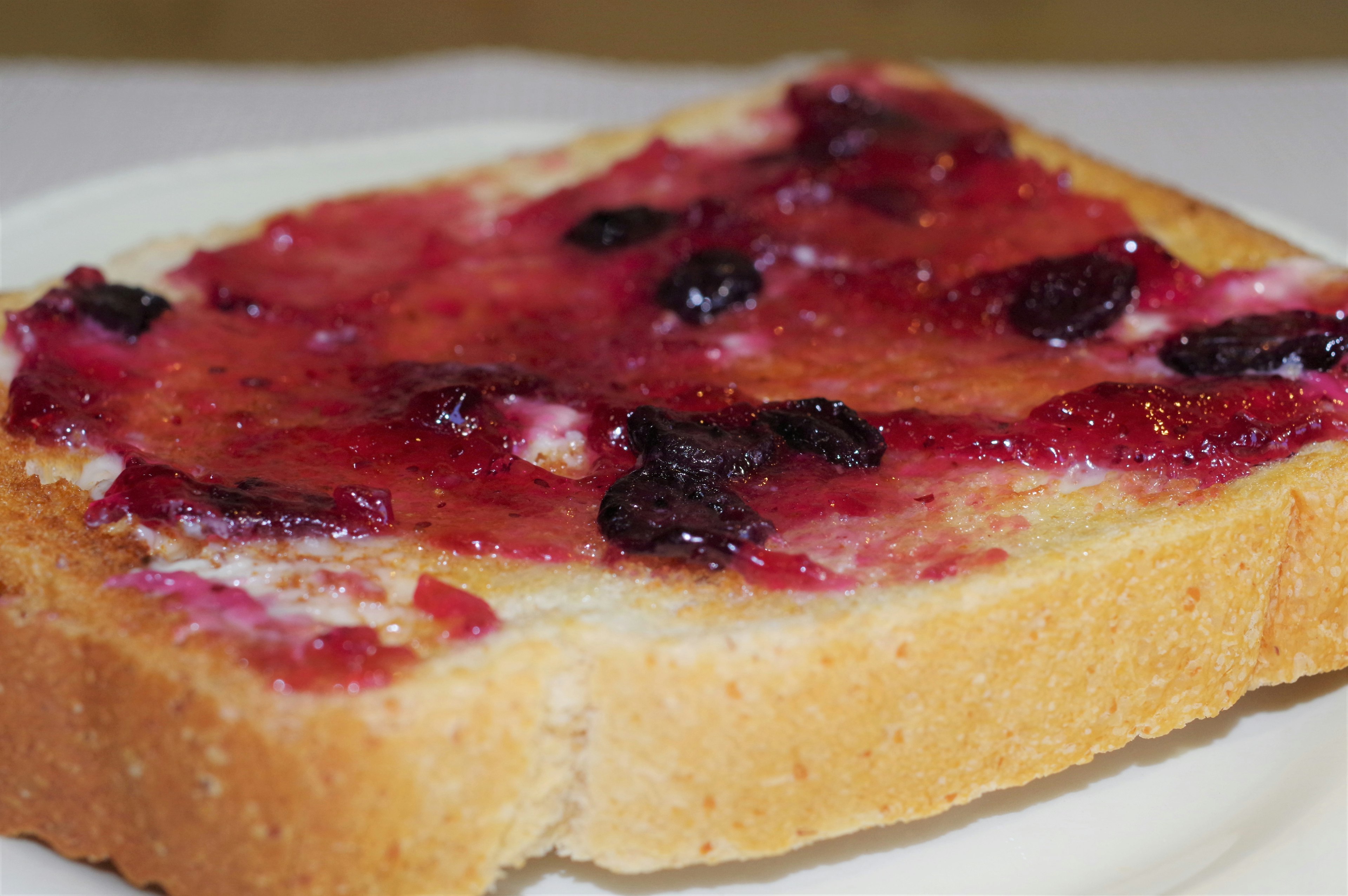 Scheibe Toast mit Marmelade auf einem weißen Teller