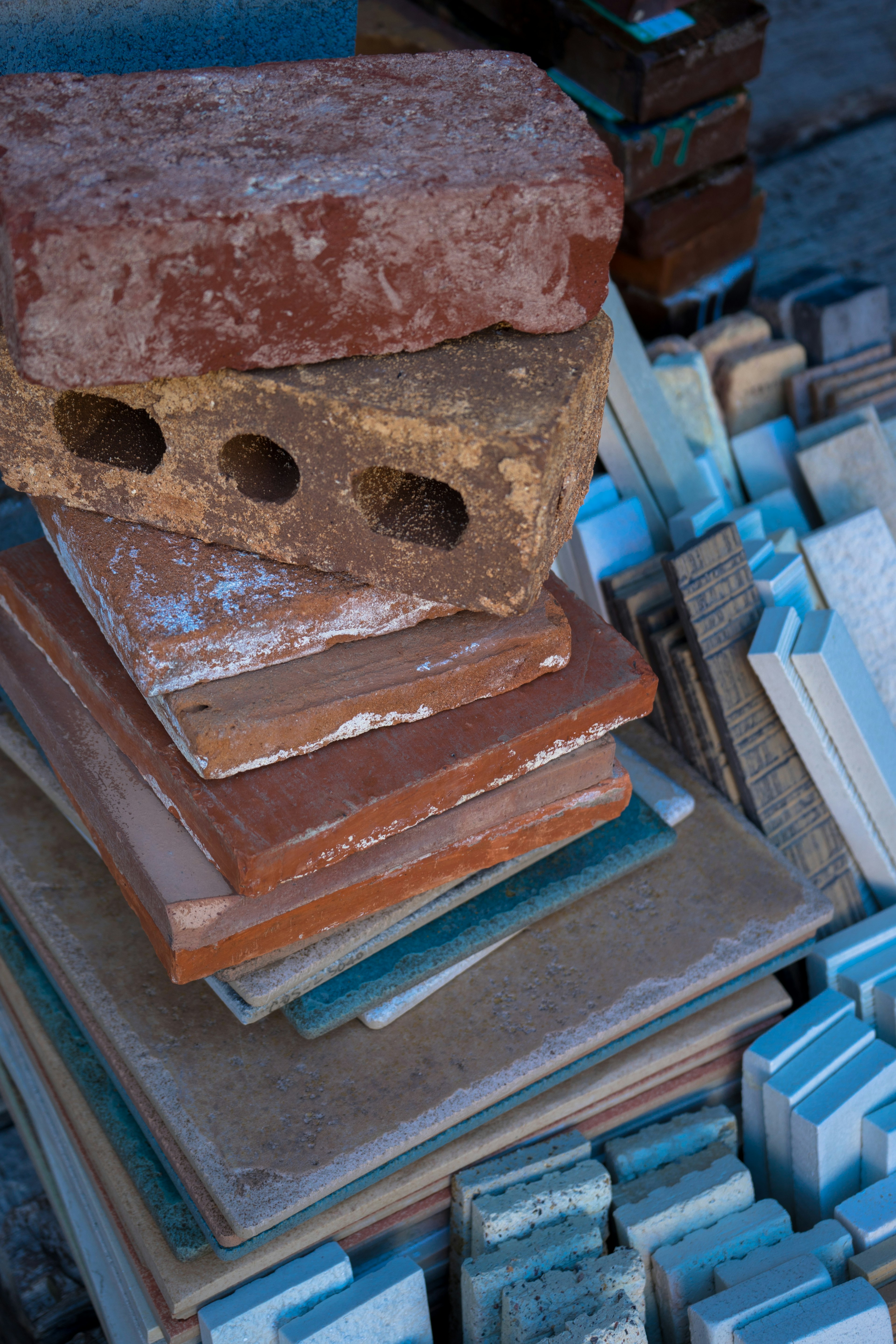 Stack of red bricks and various tiles arranged together