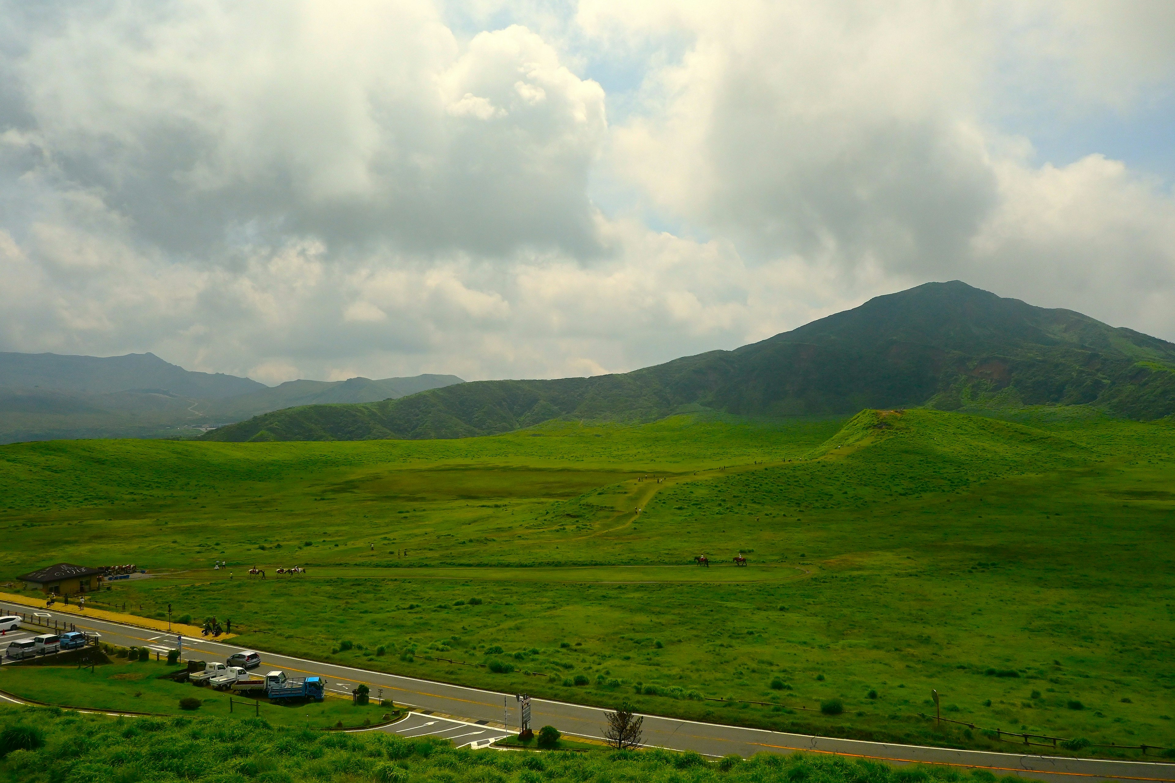 Lush green landscape with rolling hills and clouds