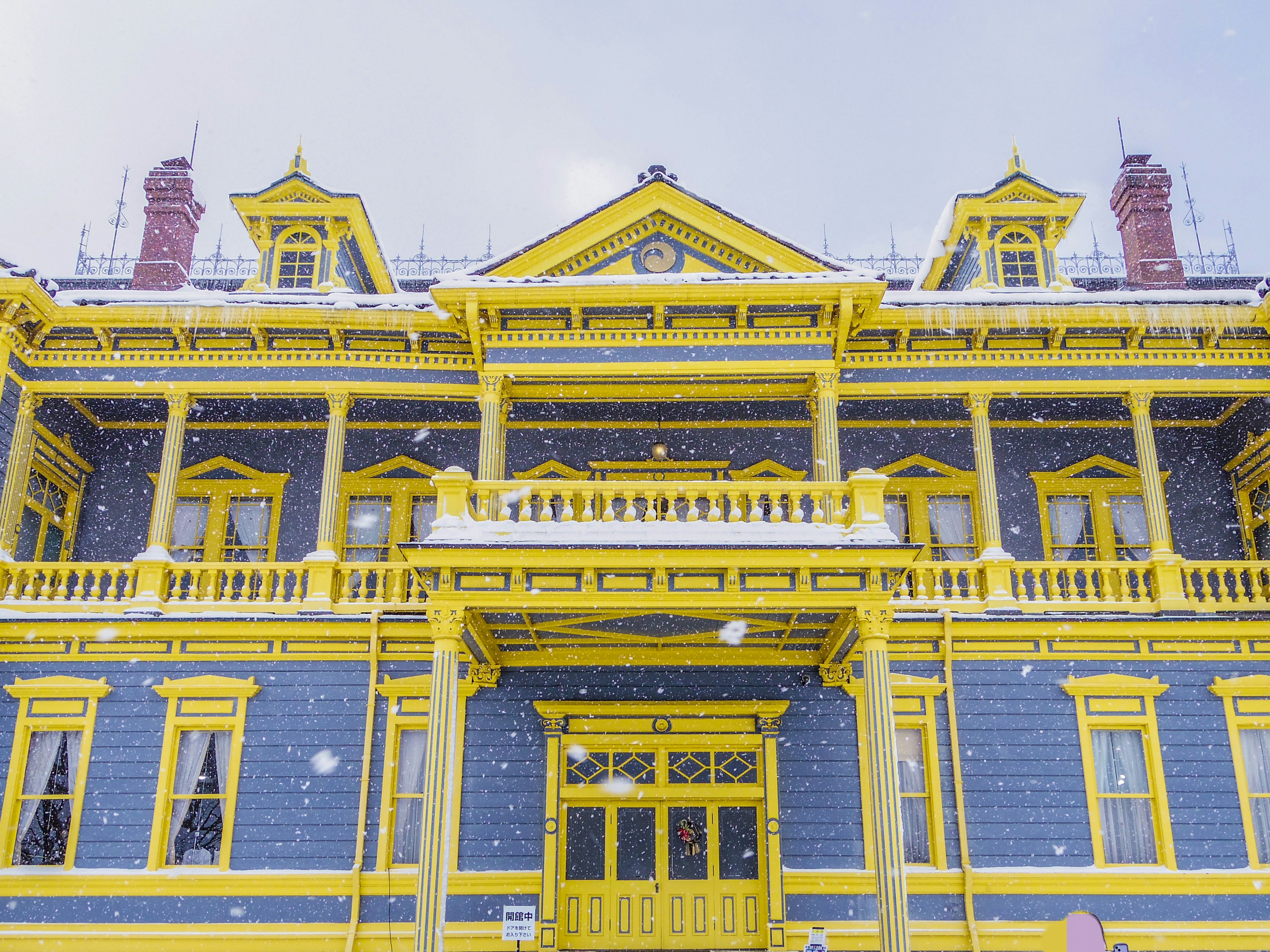 Historic building with a bright yellow facade in the snow