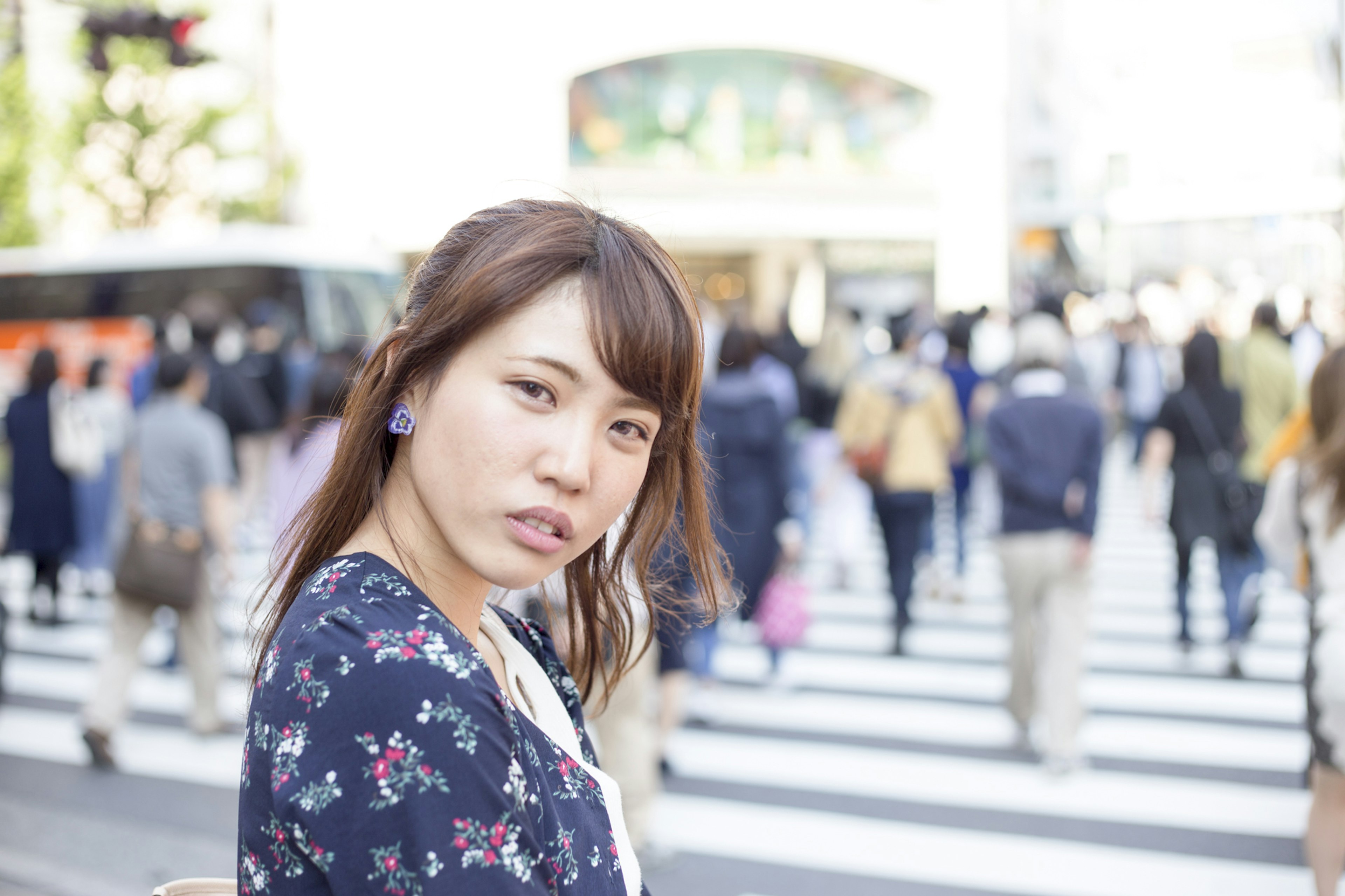 Woman turning back in a crowd wearing floral attire