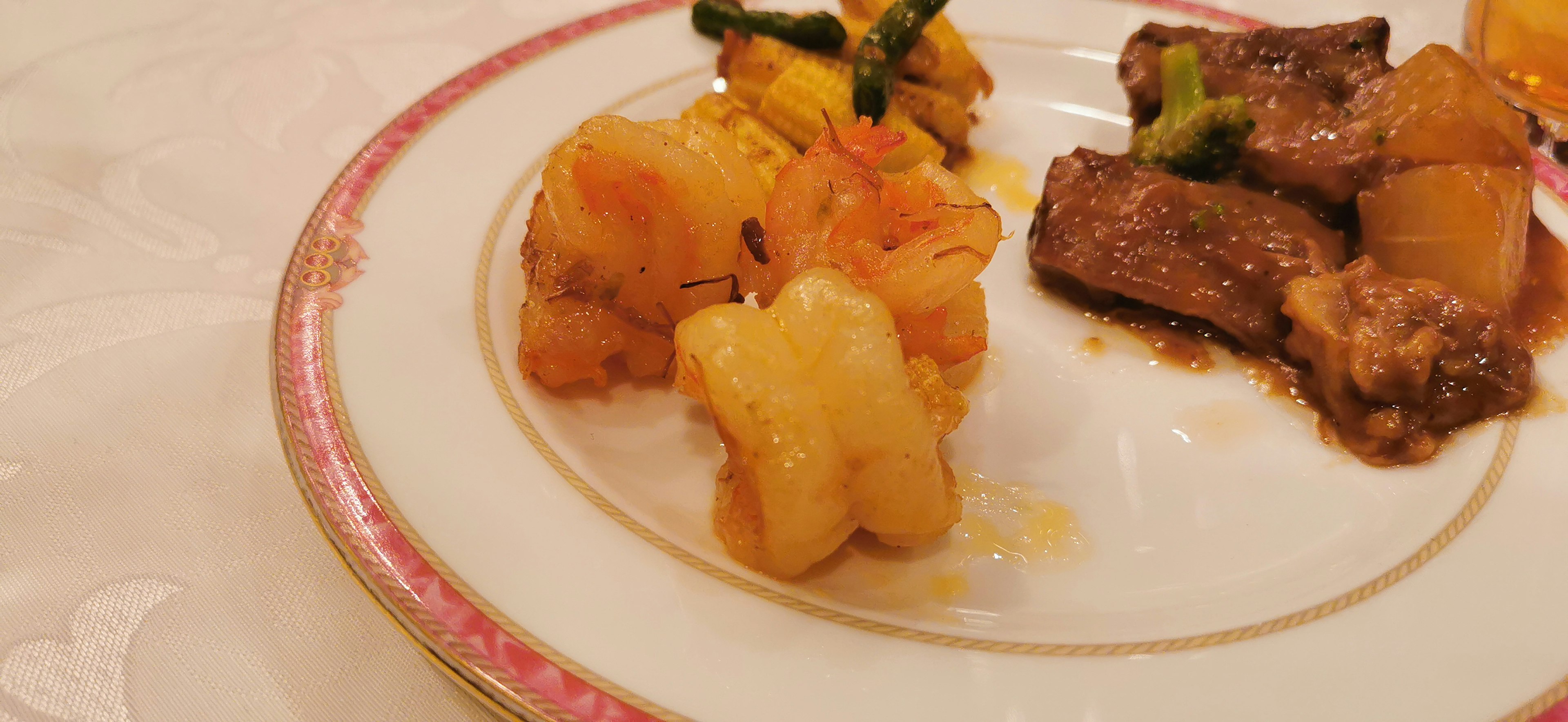 A plate of food featuring colorful vegetables and meat, with uniquely shaped side dishes