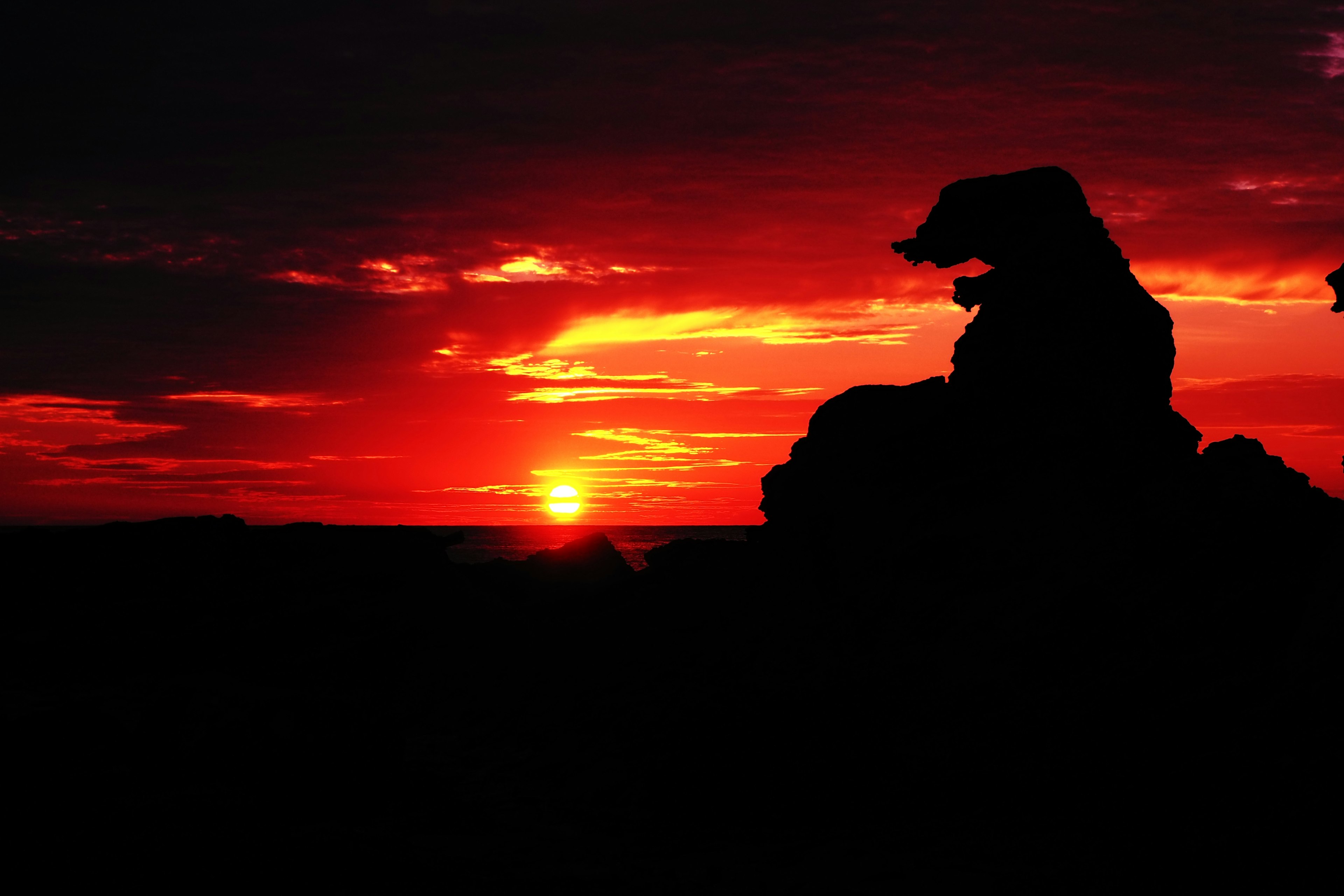 Silhouette of rocks against a sunset sky