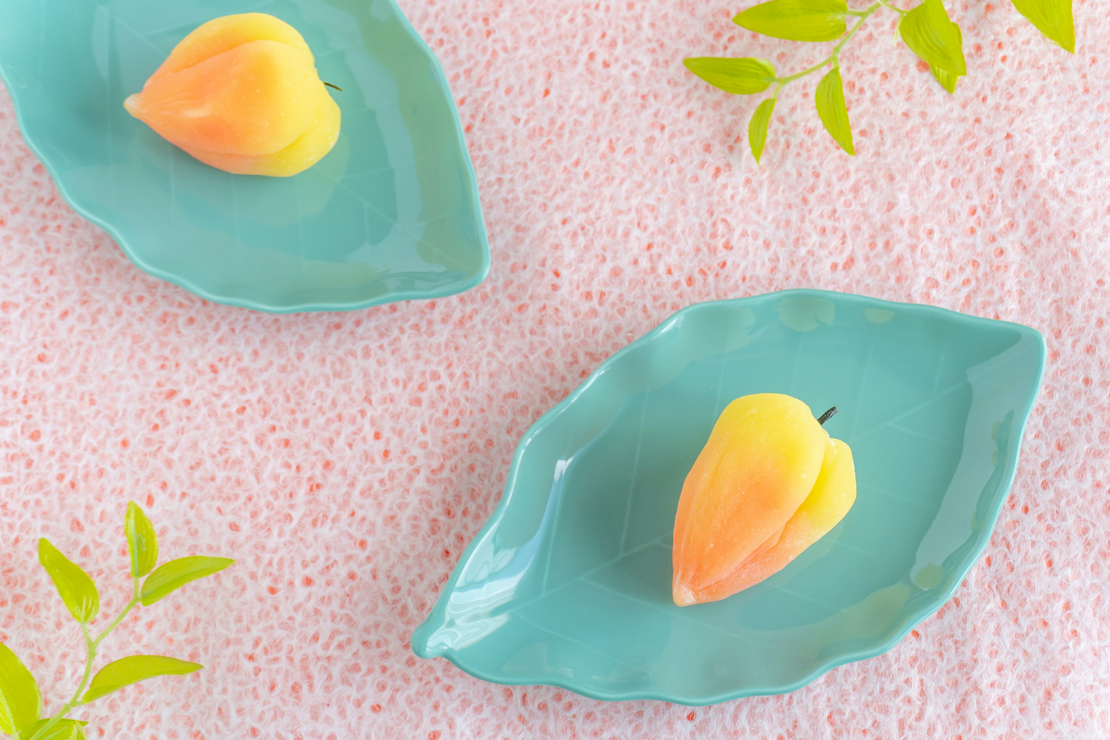 Colorful dessert on blue leaf-shaped plates