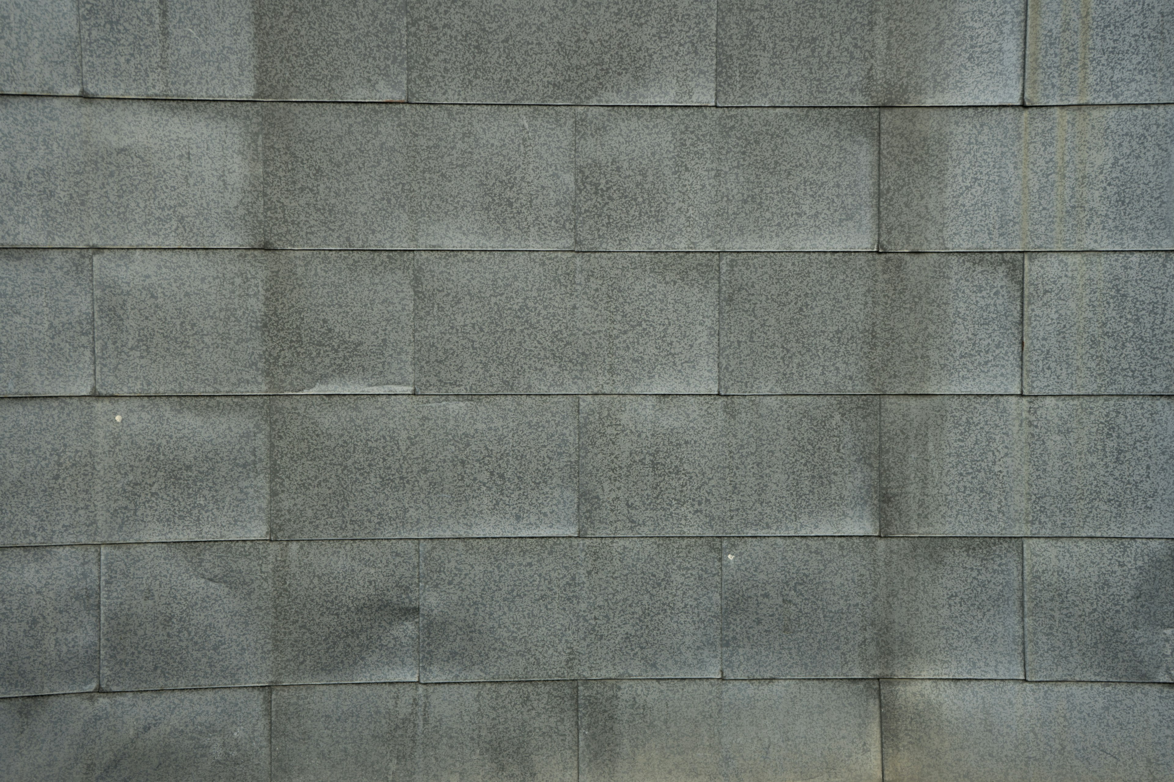 Texture of a wall made of neatly arranged gray blocks