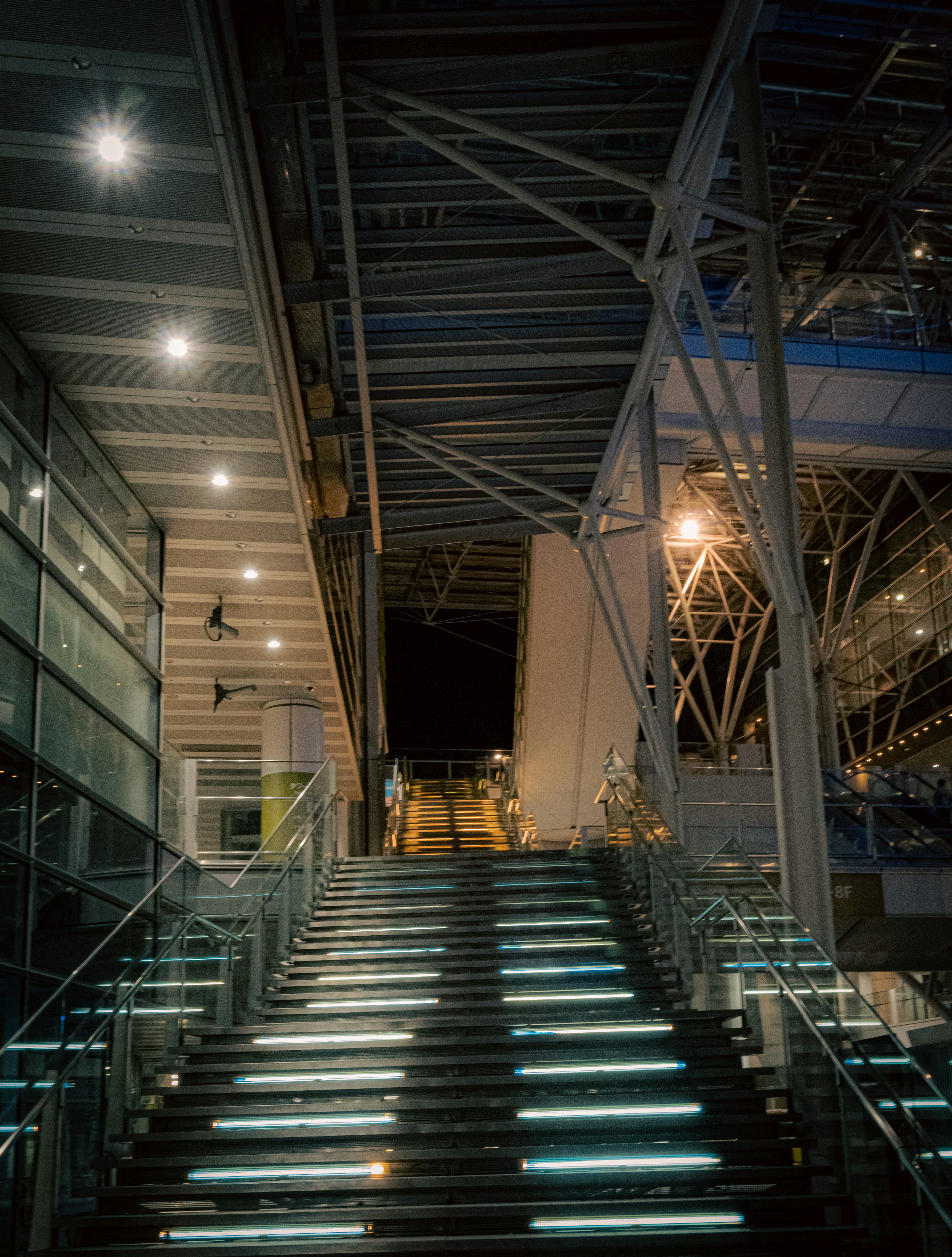 Modern building interior with illuminated stairs at night