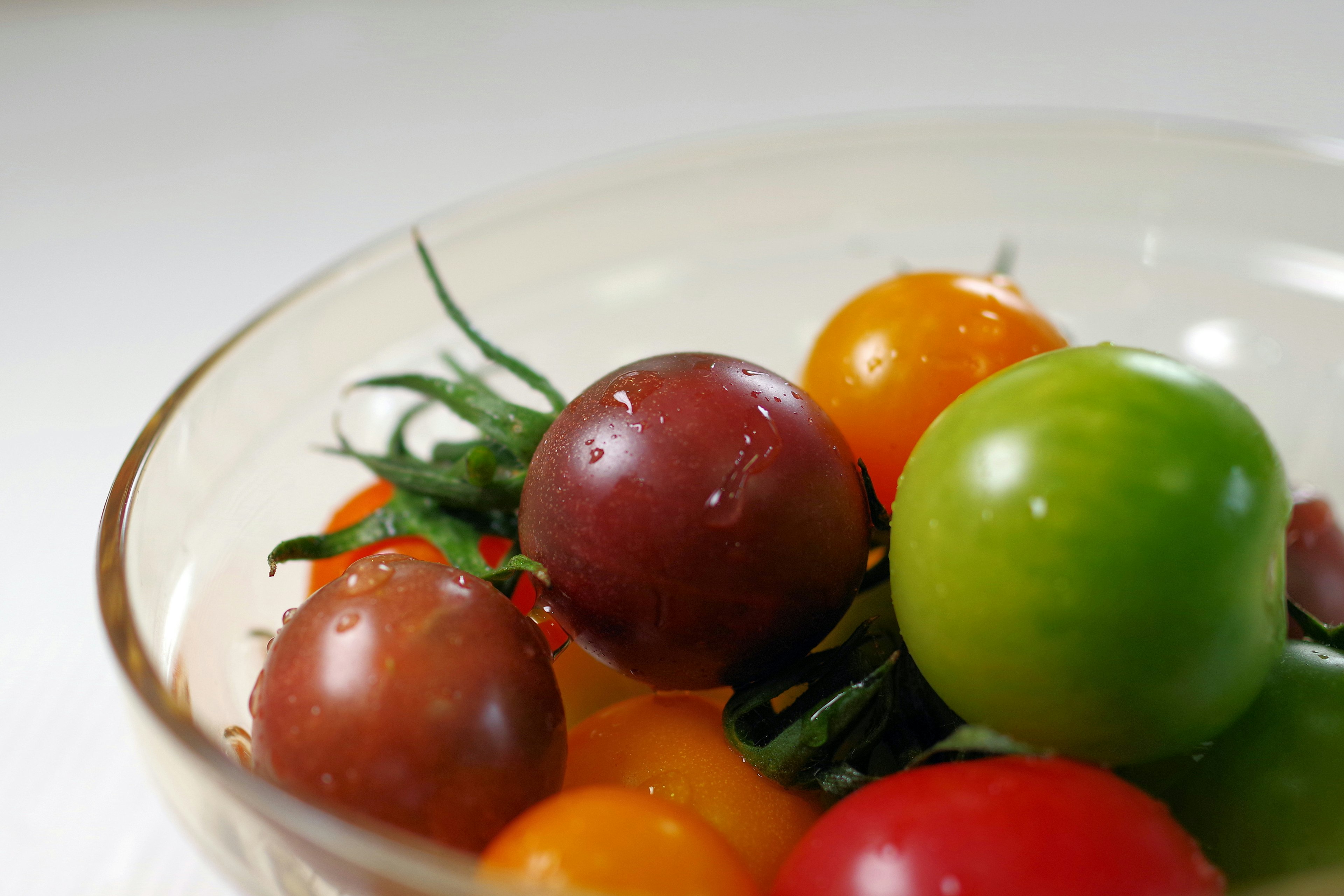 Colorful tomatoes in a glass bowl