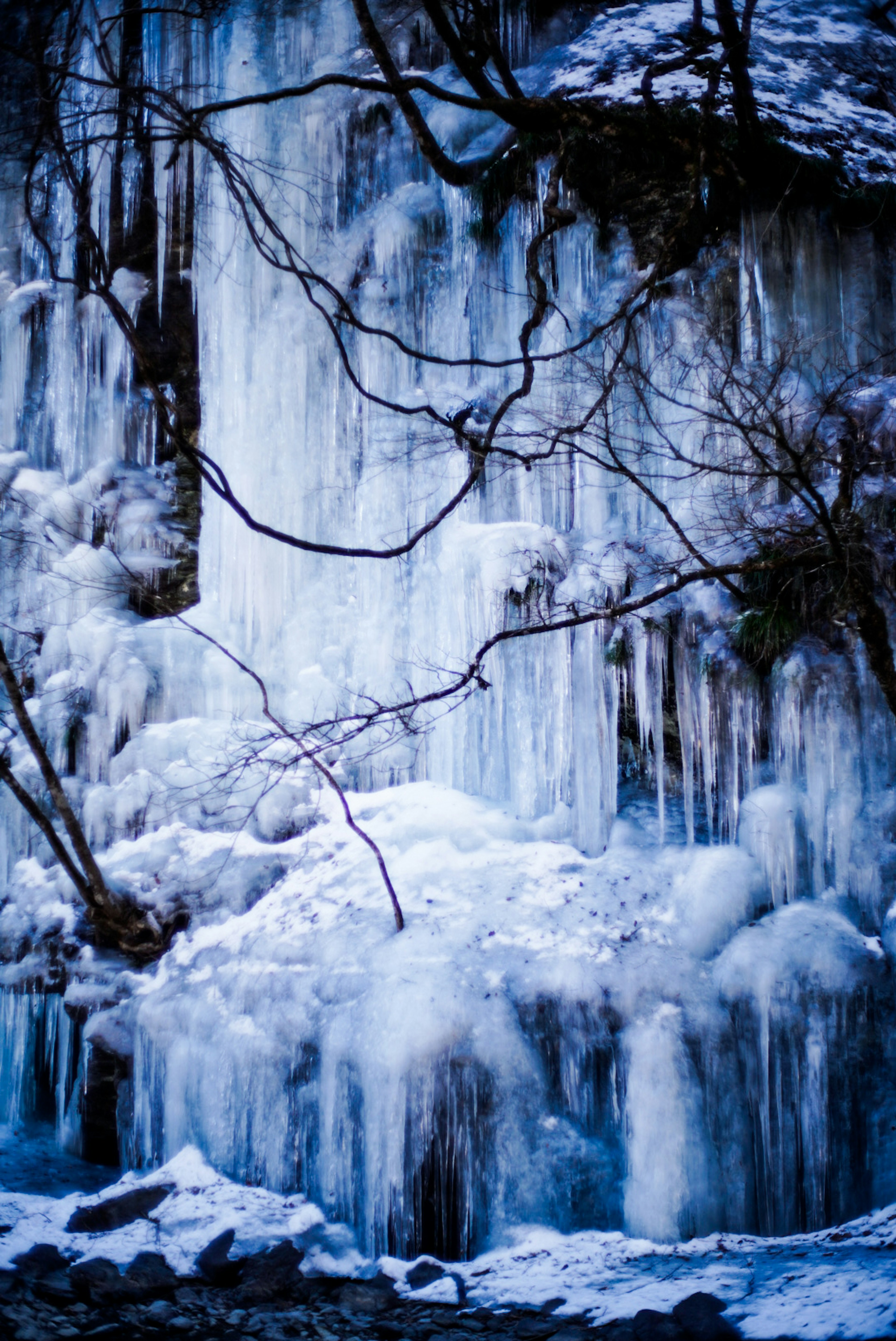 Beautiful view of an ice-covered waterfall with layers of bluish-white ice