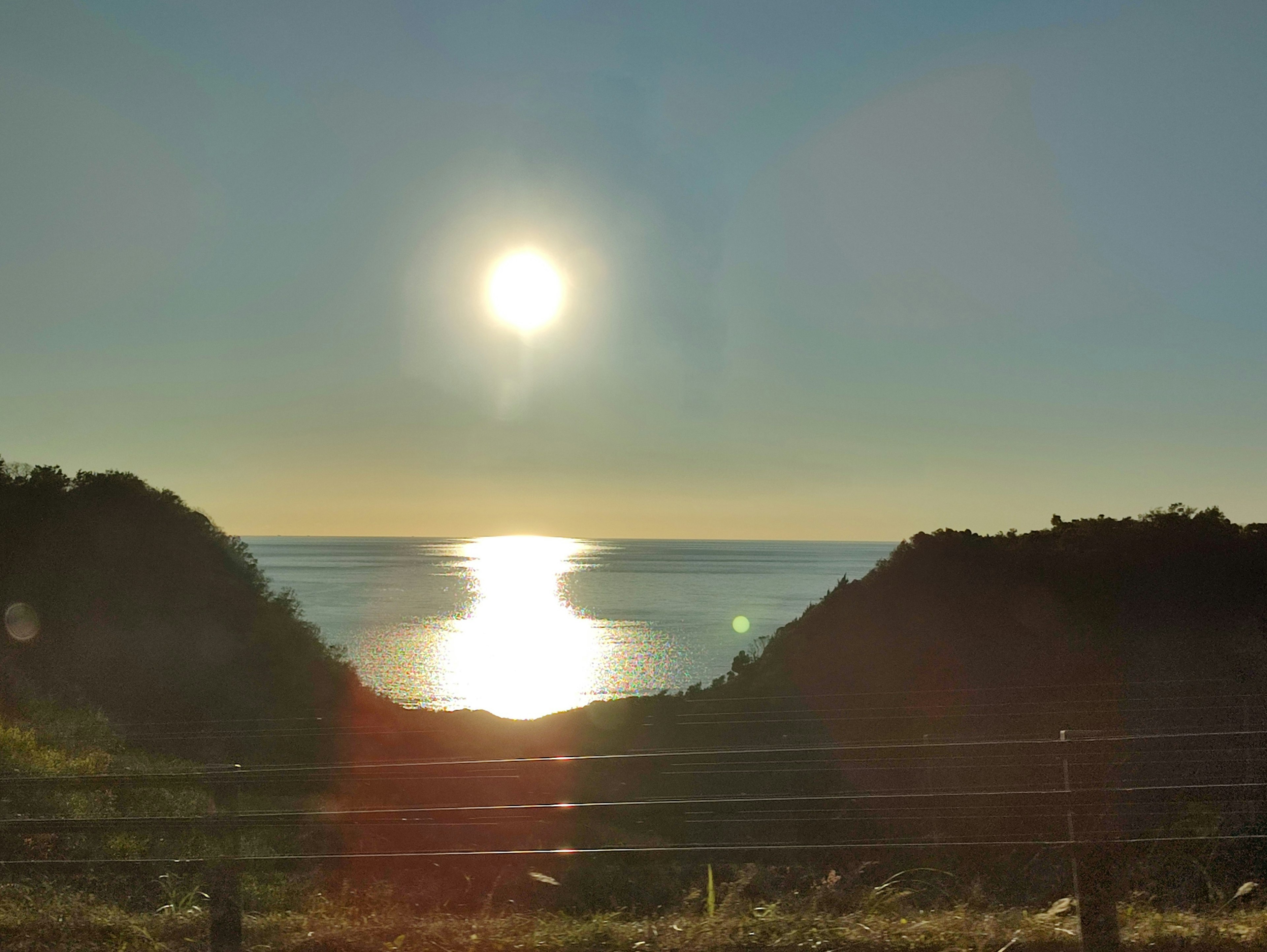 Scenic view with the sun reflecting on the ocean