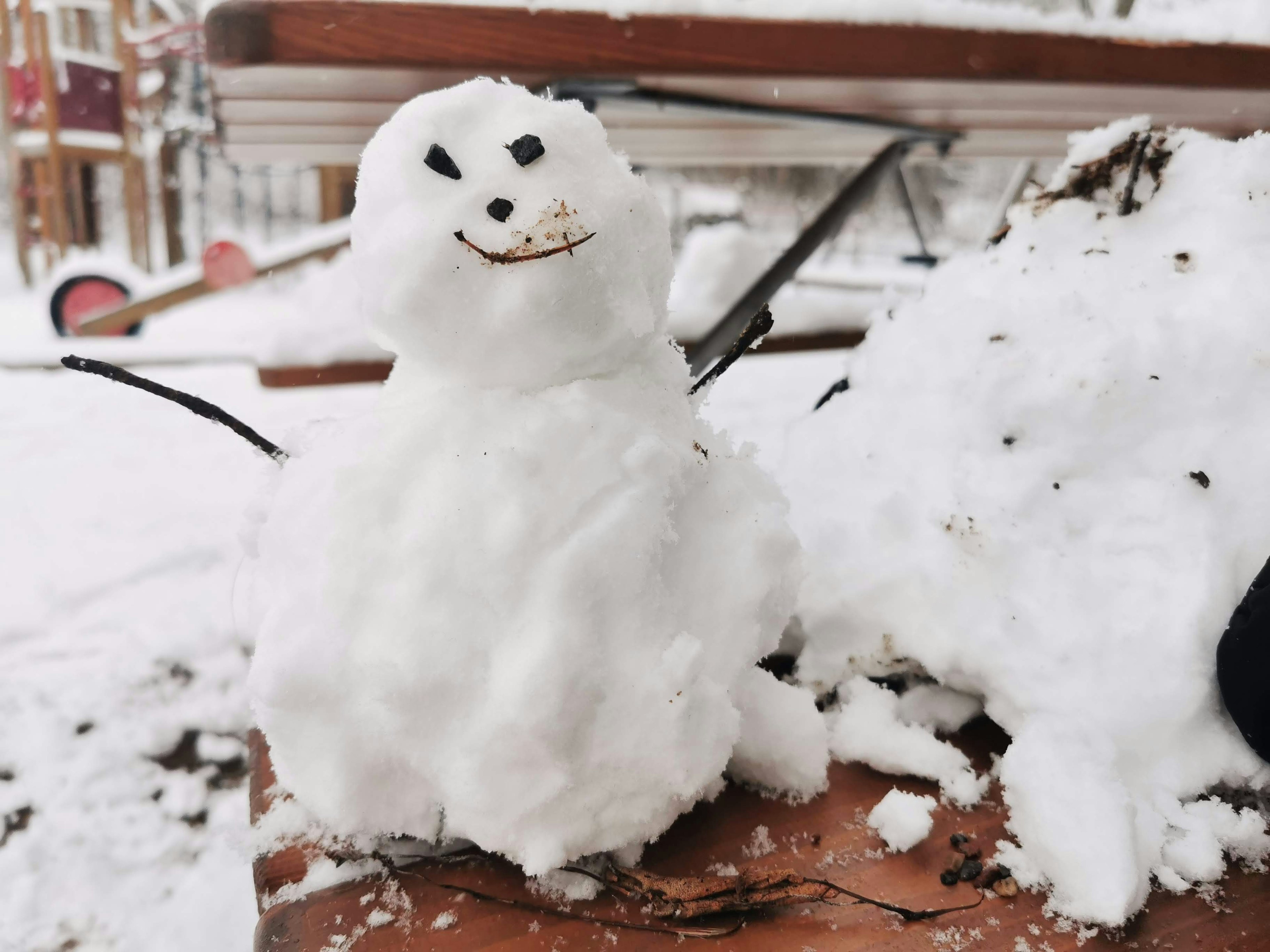 A smiling snowman in a snowy landscape