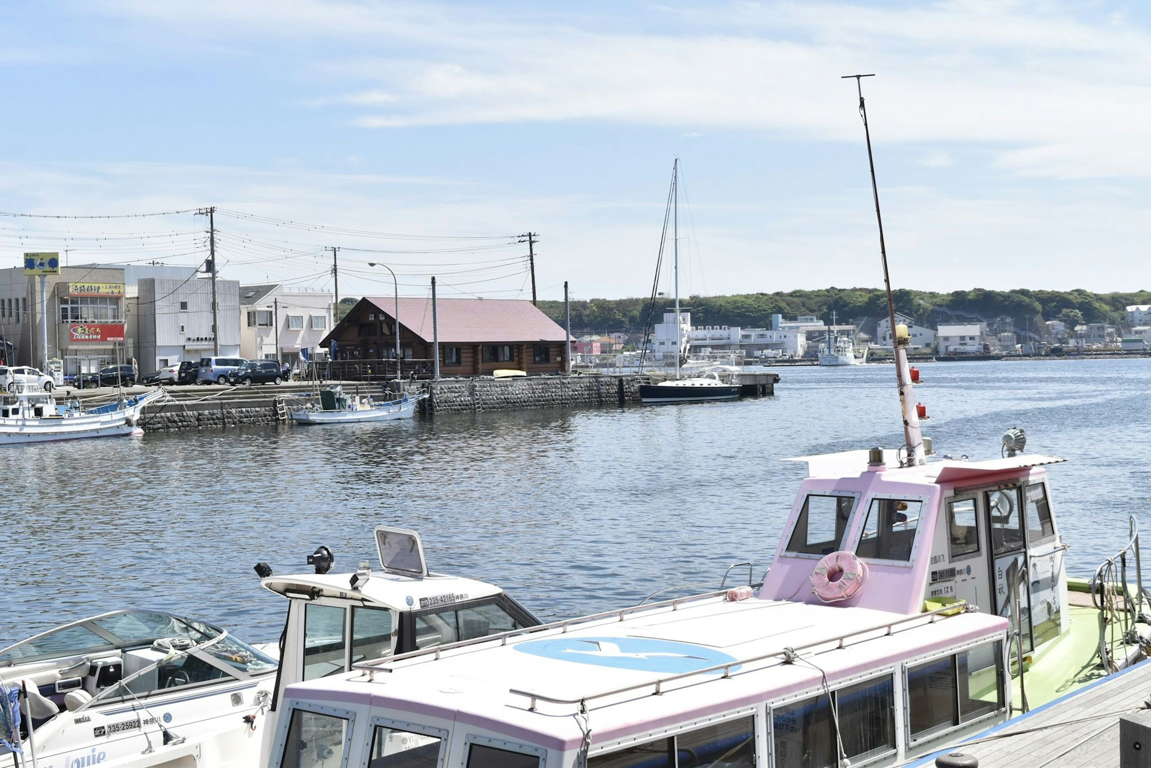 Boats docked at a harbor with a clear blue sky