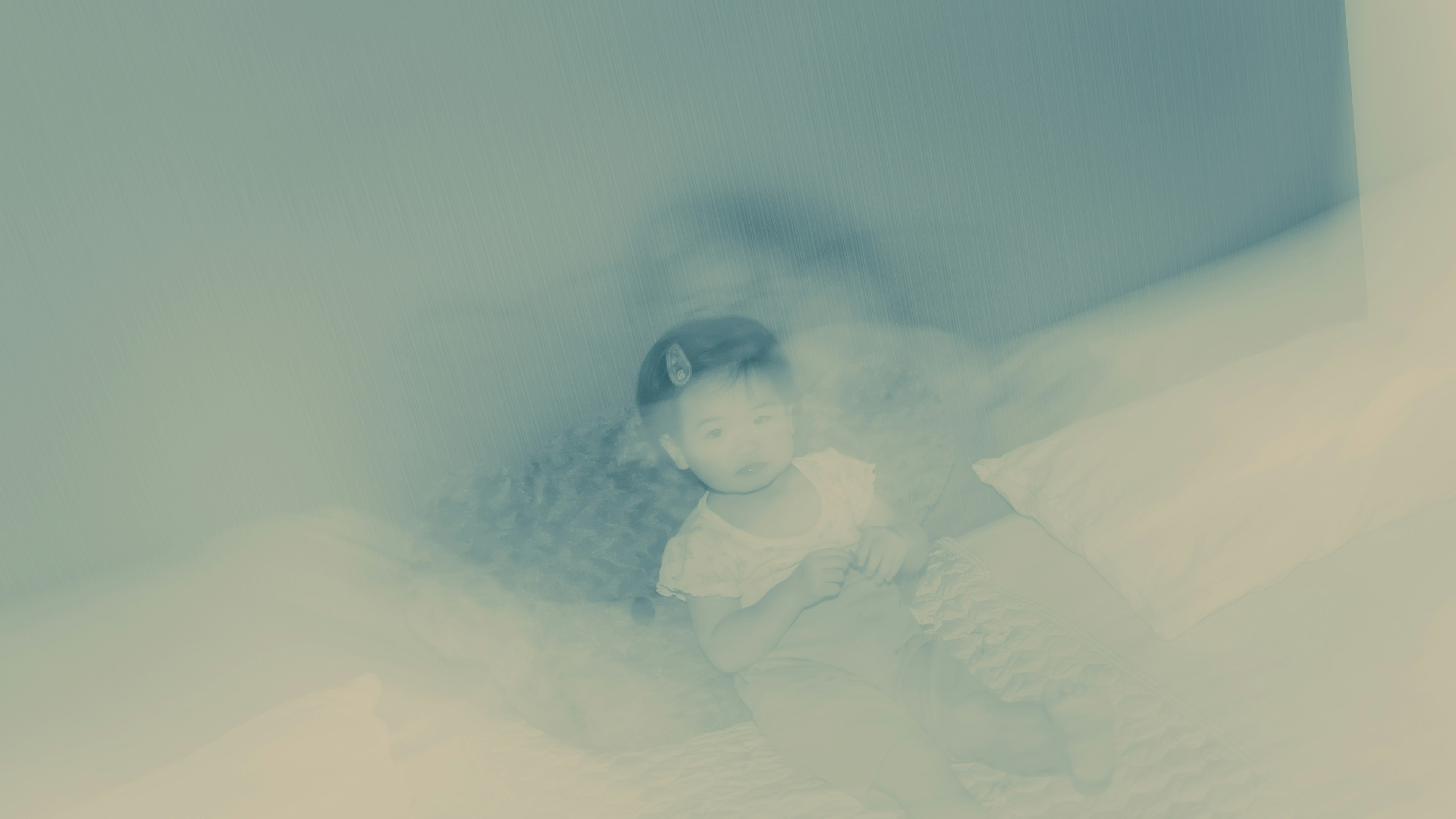 Blurred image with a white object partially submerged in a blue background