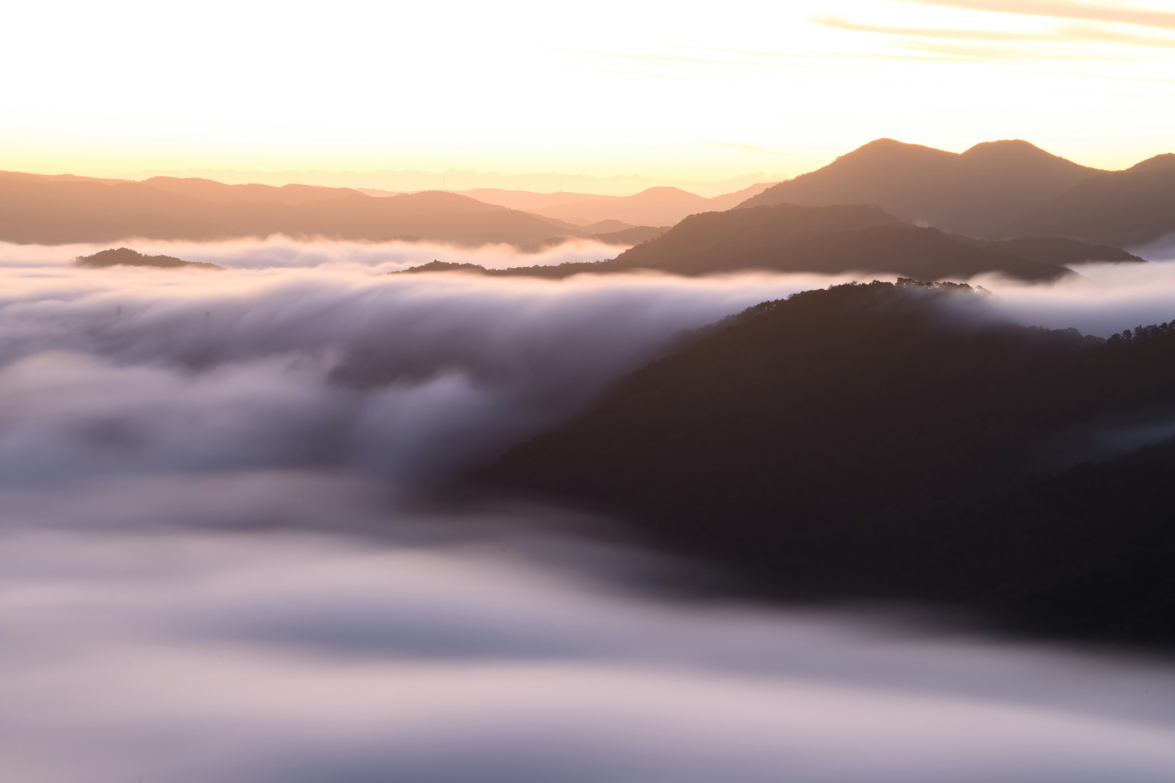 Vue panoramique des montagnes et de la mer de nuages au lever du soleil