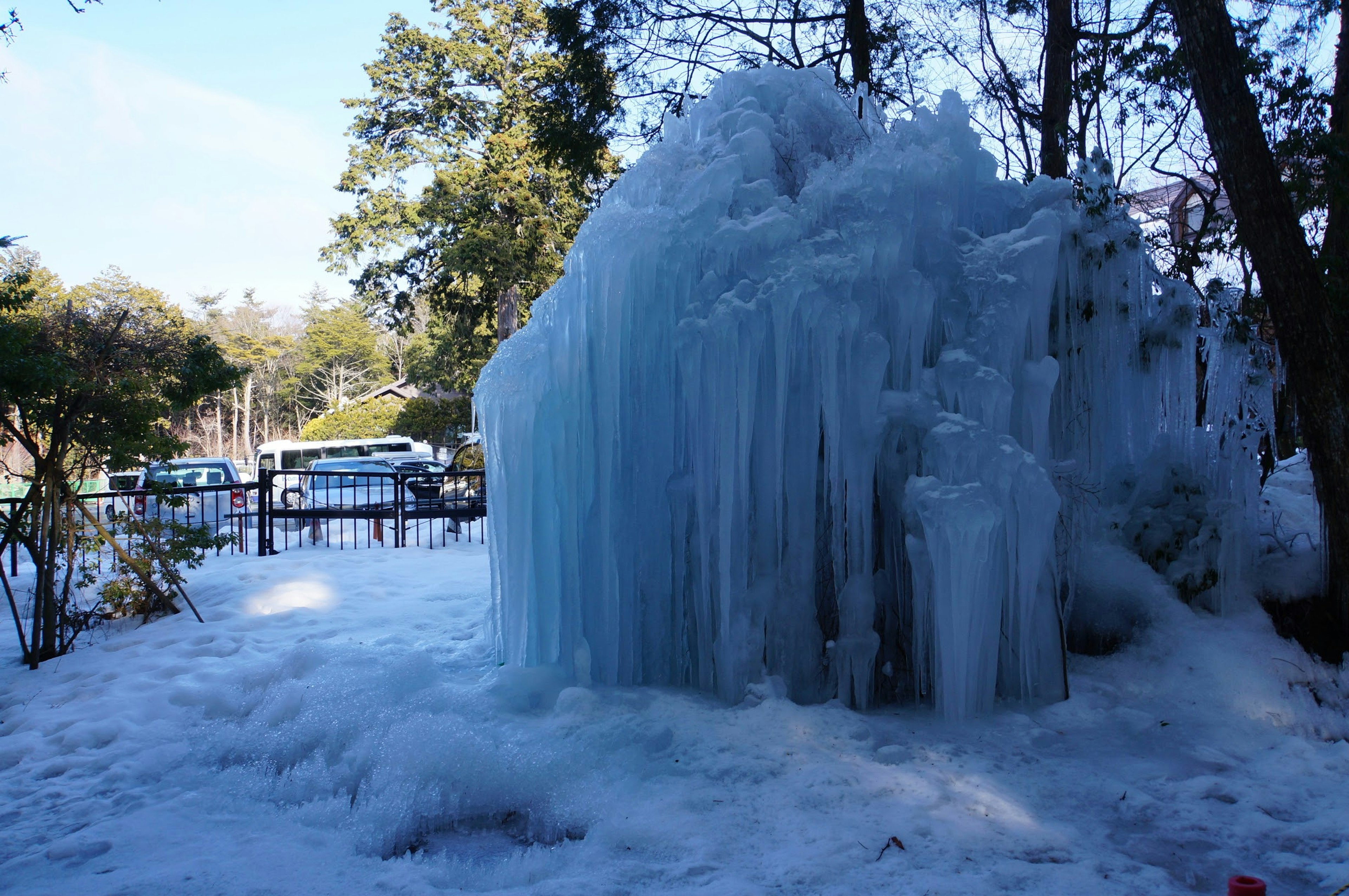 A large formation of ice surrounded by snow in a winter landscape