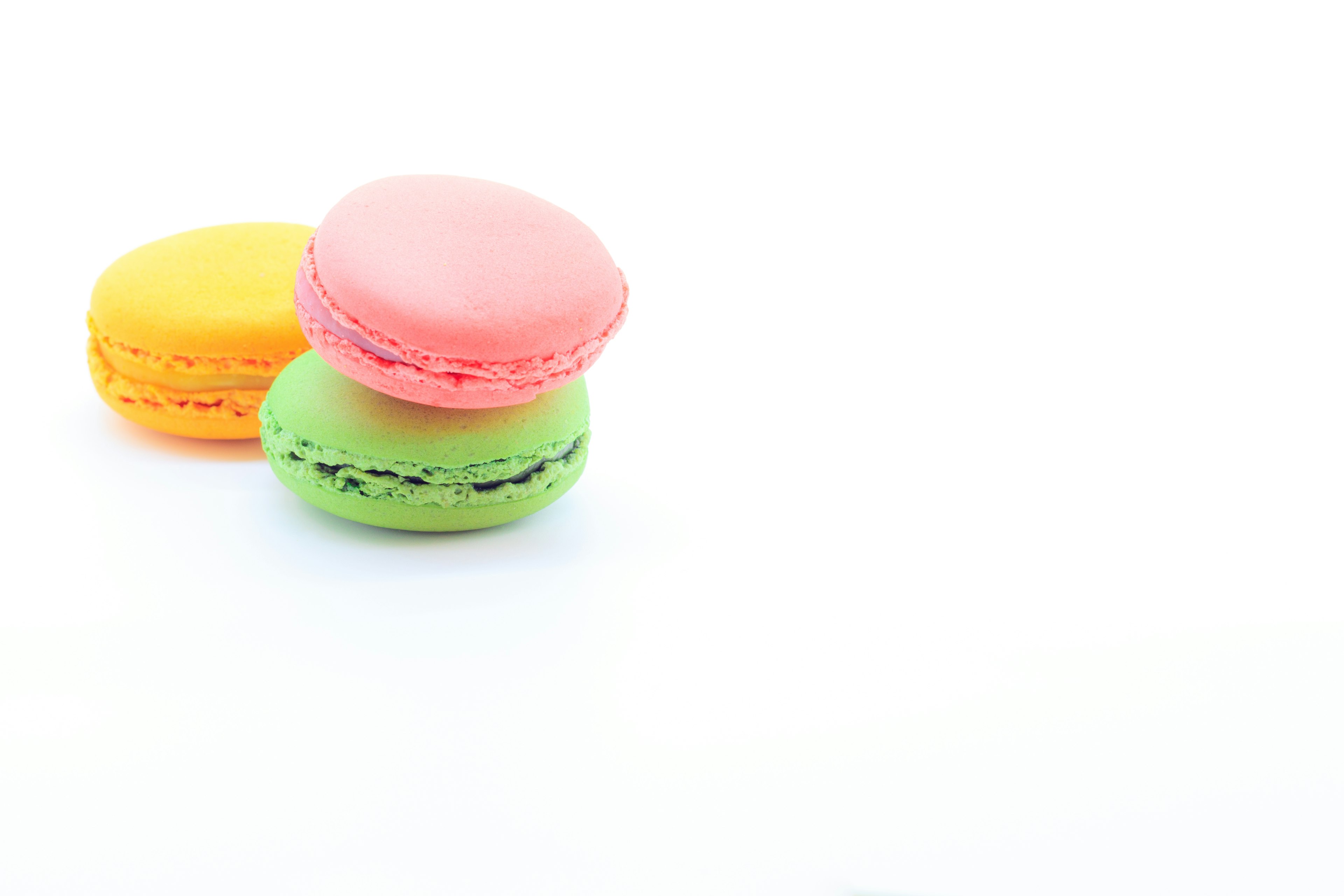 Colorful macarons arranged on a white background