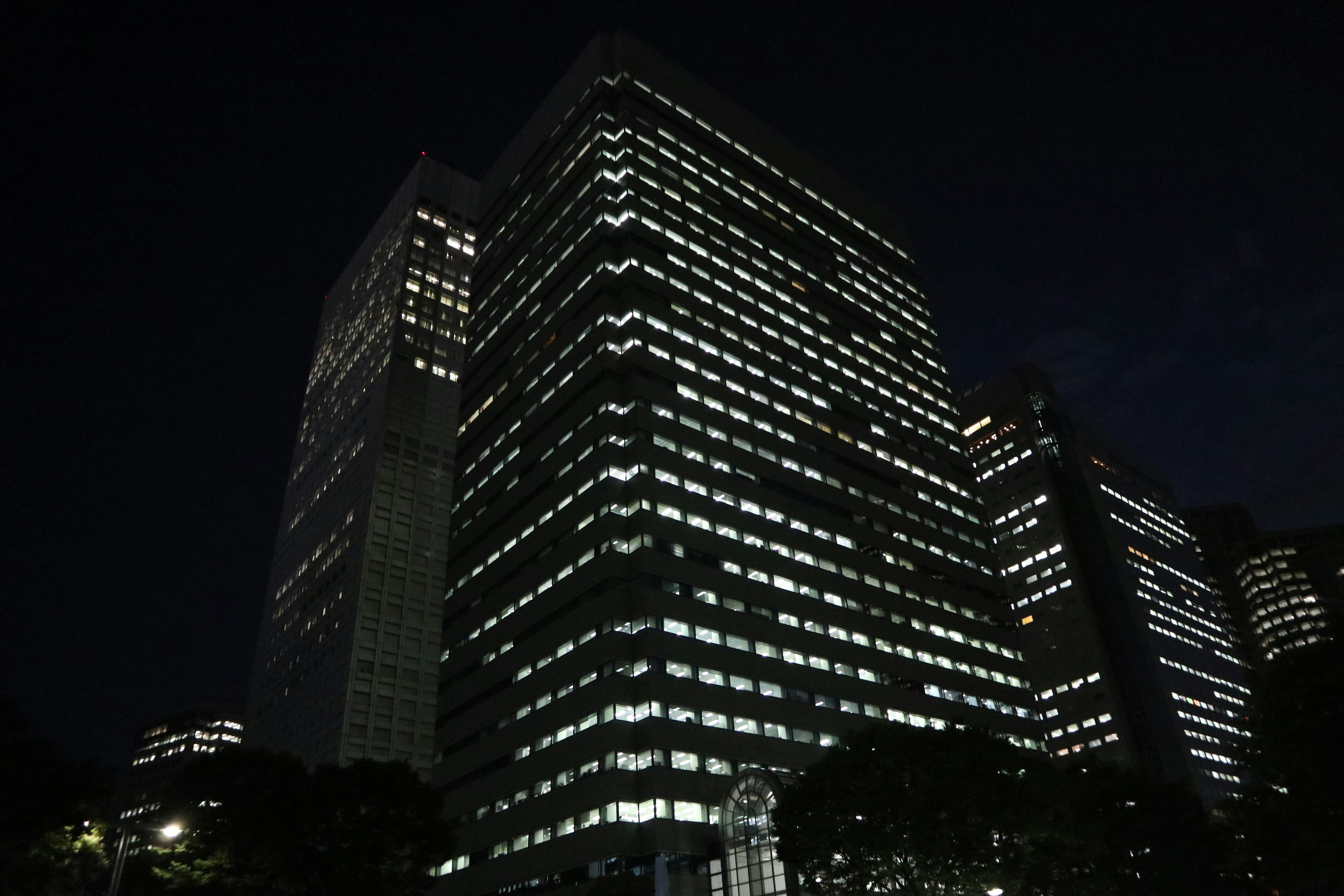 Tall skyscrapers illuminated at night in an urban setting