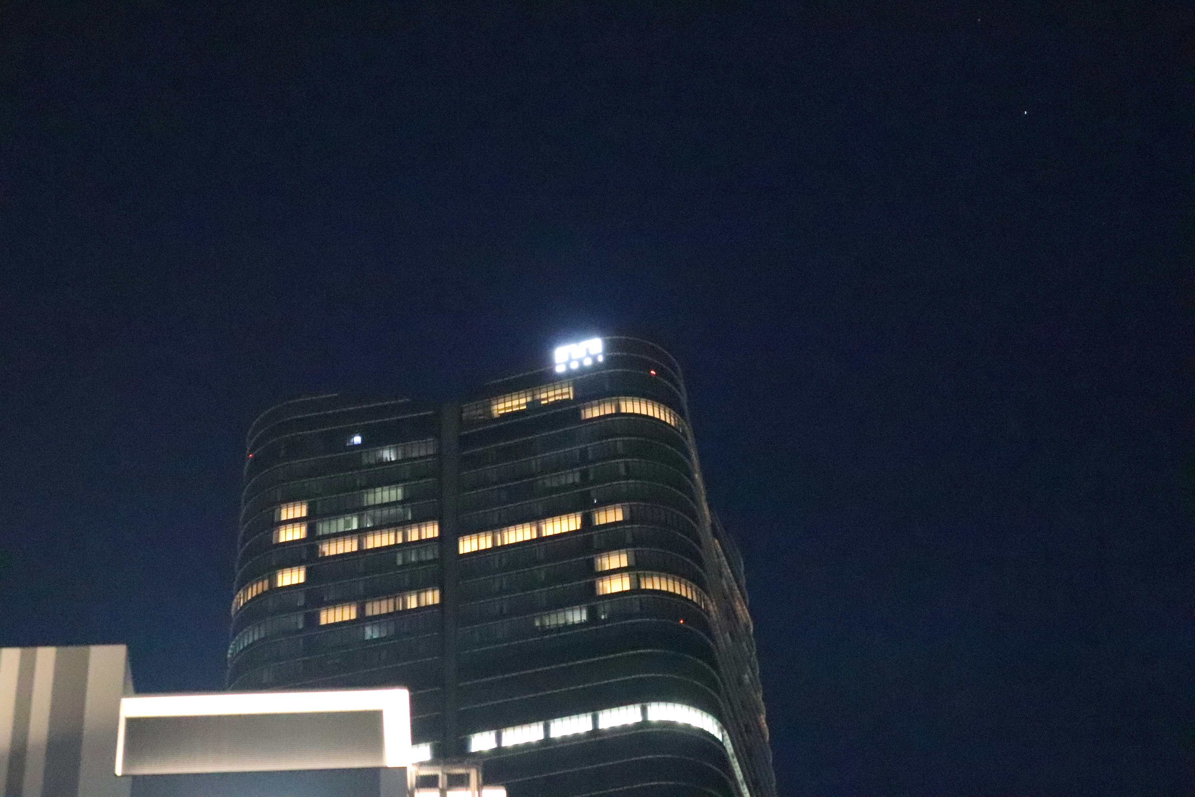 Edificio de gran altura iluminado contra el cielo nocturno