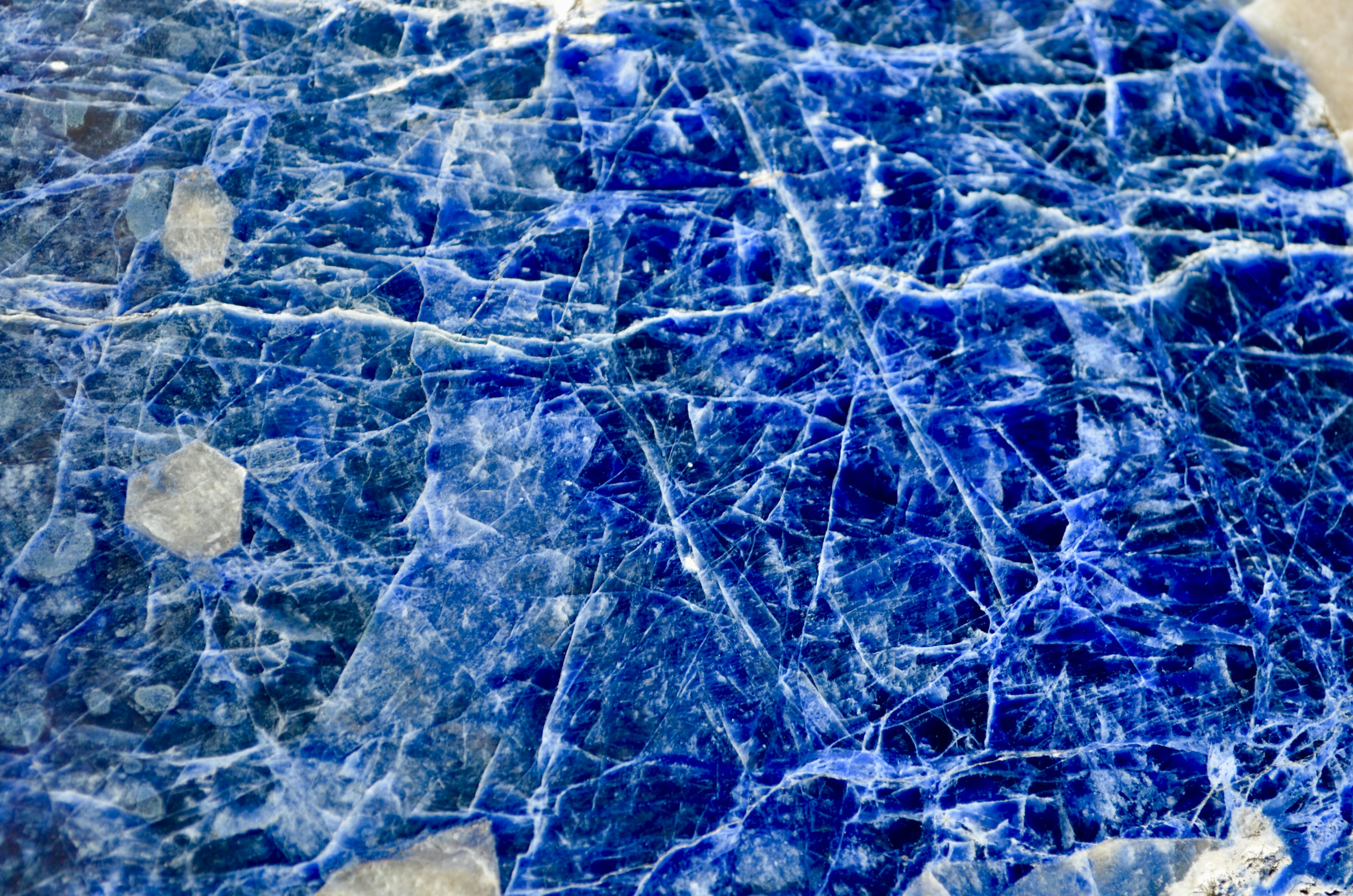 Close-up of a blue stone with intricate patterns and cracks