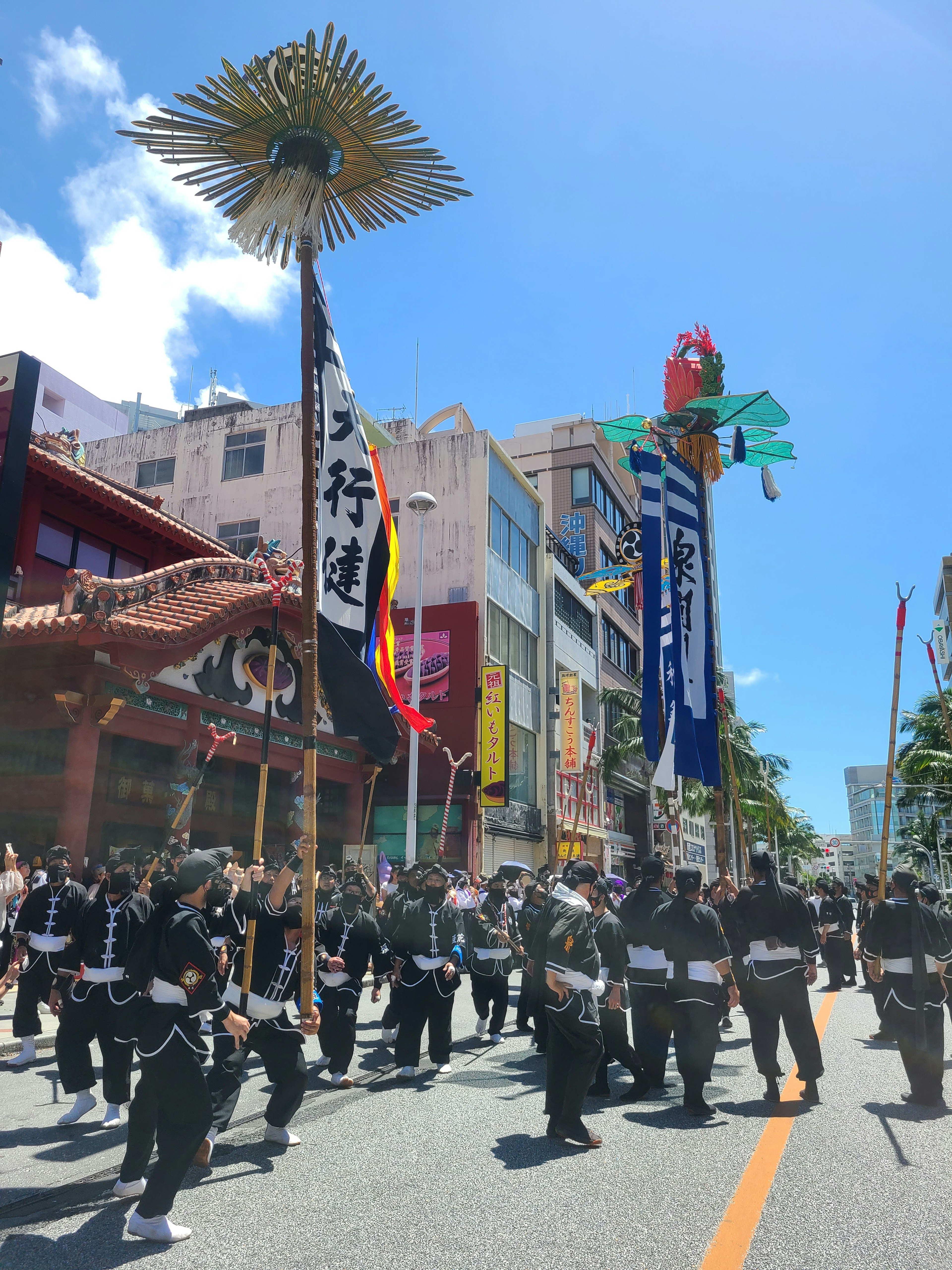 People in black clothing participating in a traditional festival parade in Okinawa