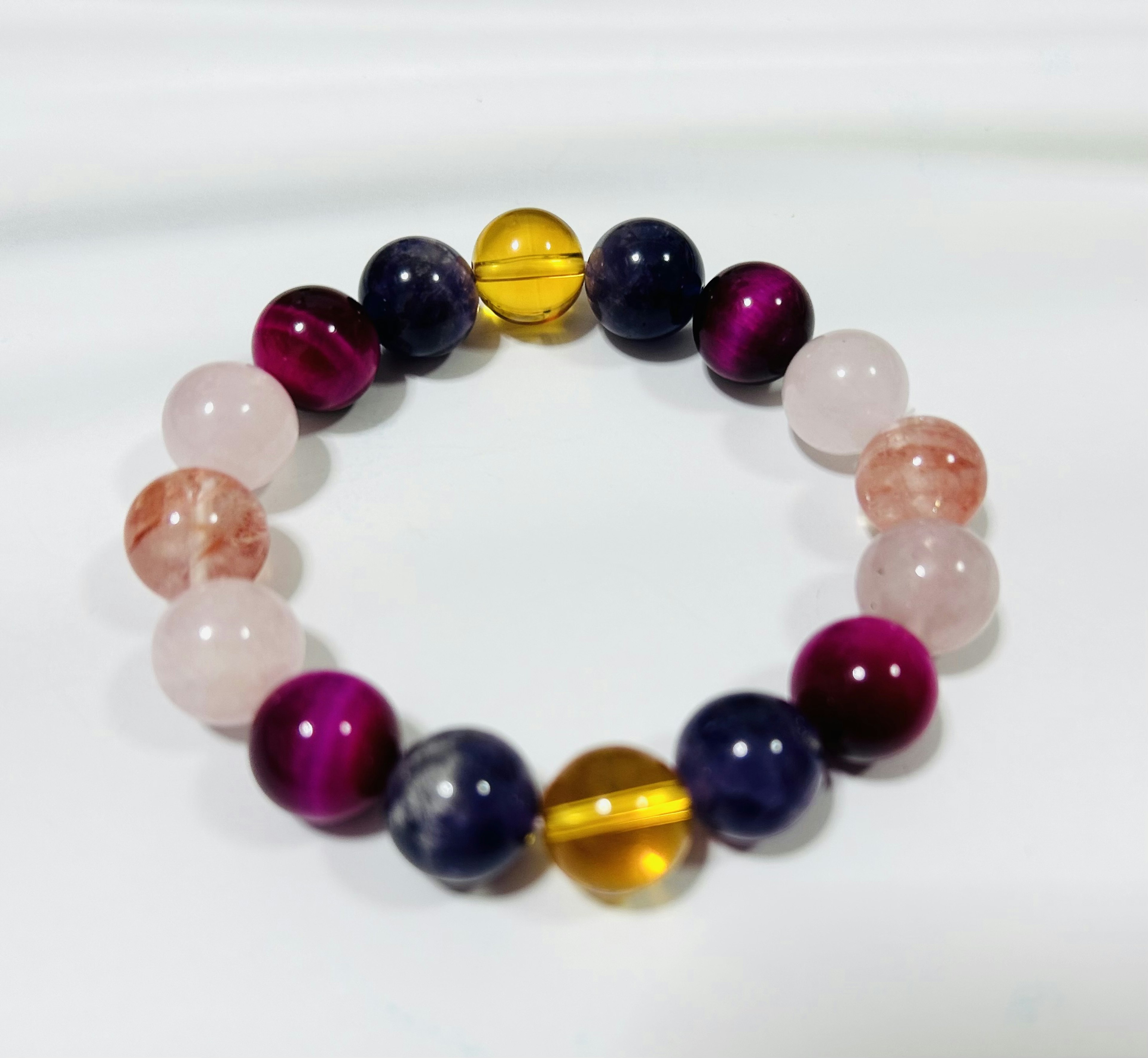 Colorful bead bracelet displayed on a white background