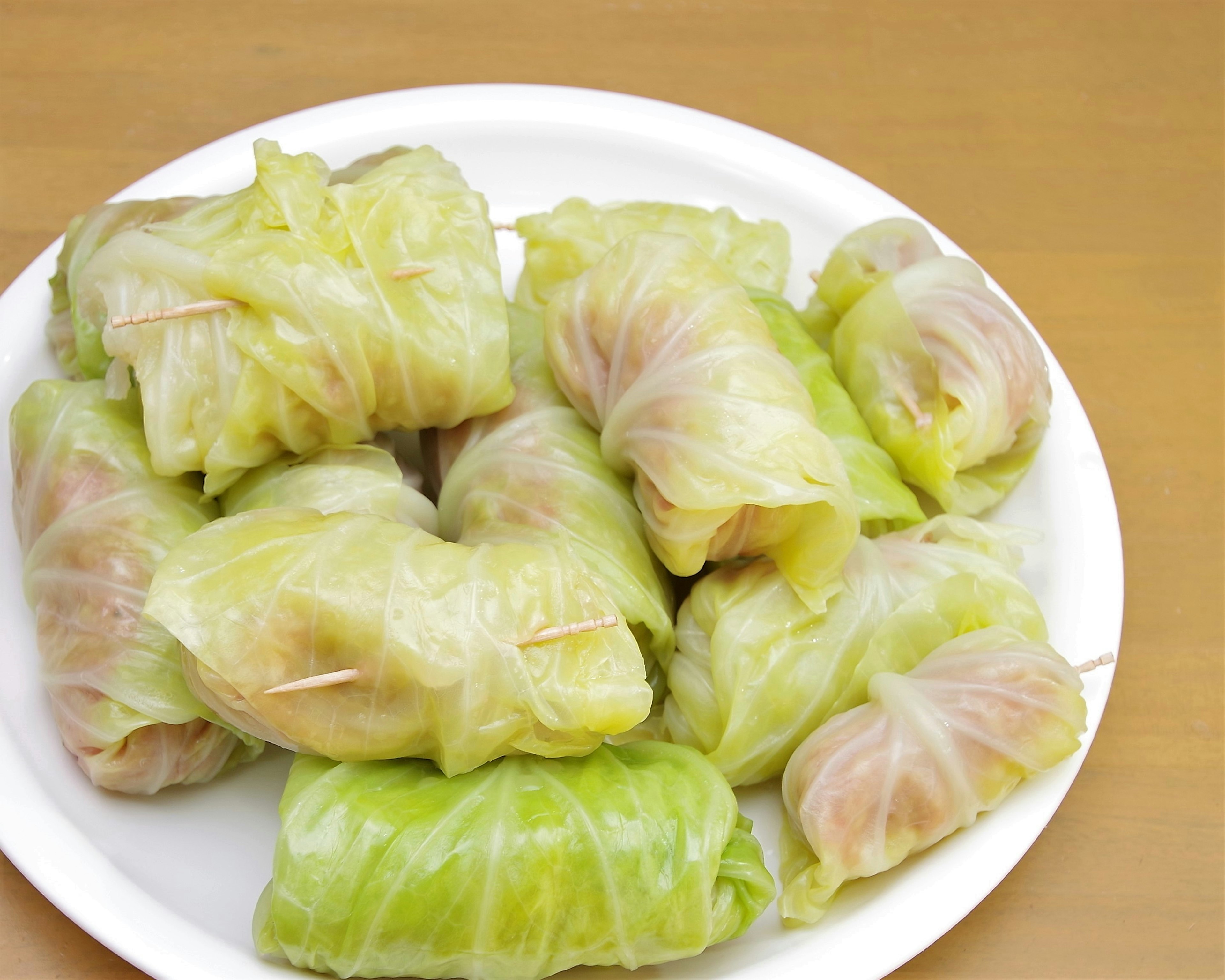 Cabbage rolls arranged on a white plate