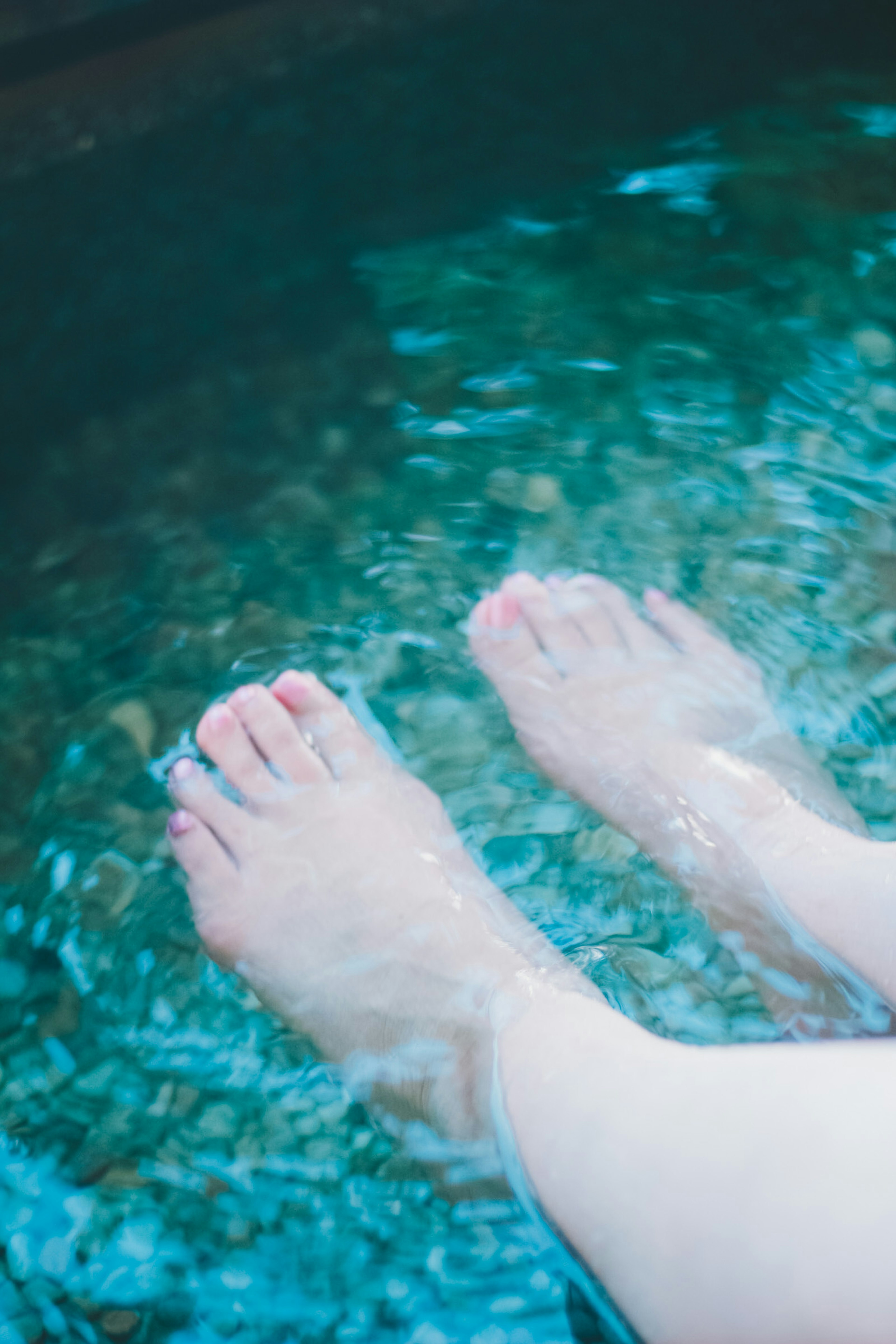 Feet submerged in clear water