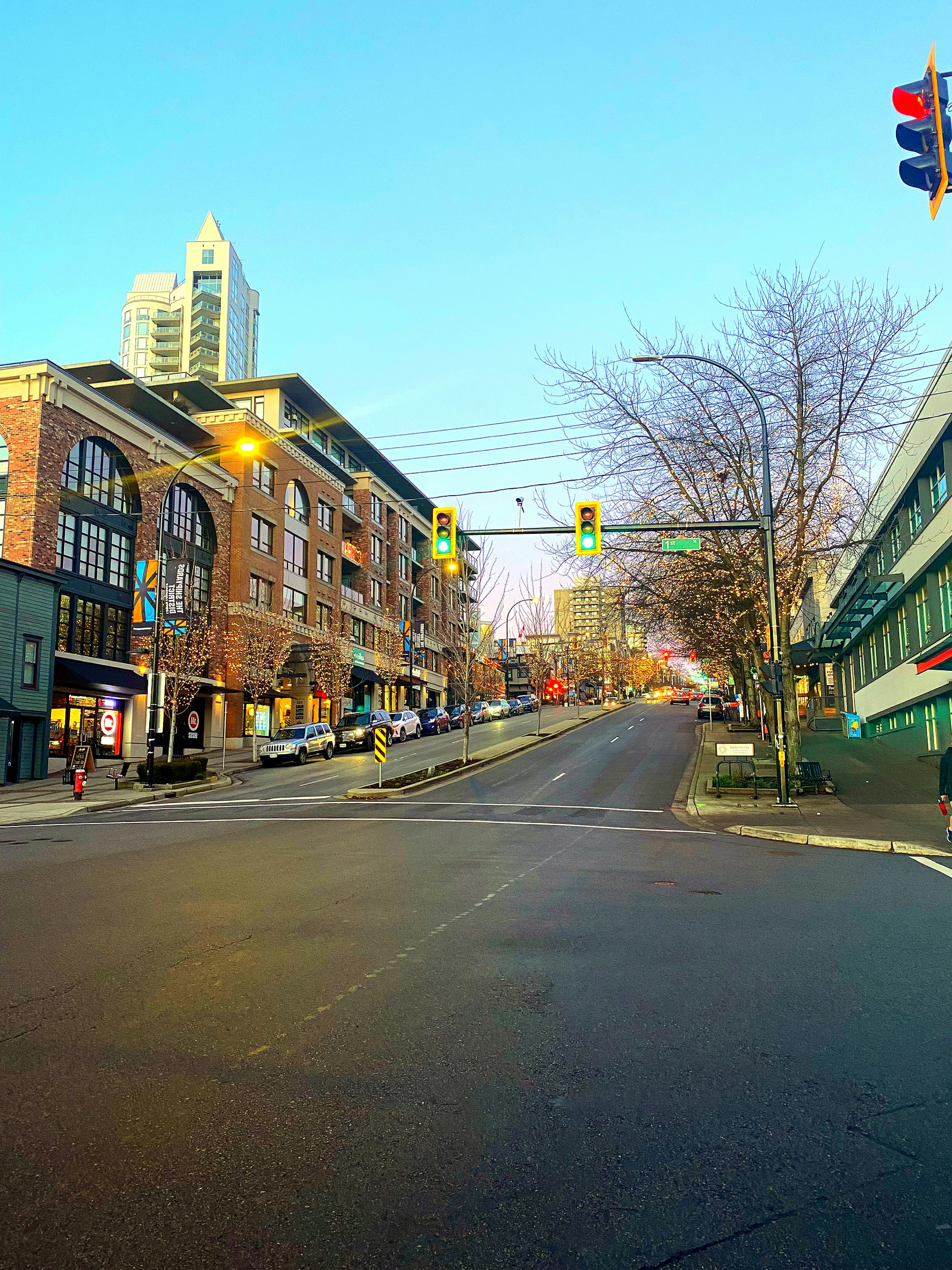 Quiet street with commercial buildings under a blue sky