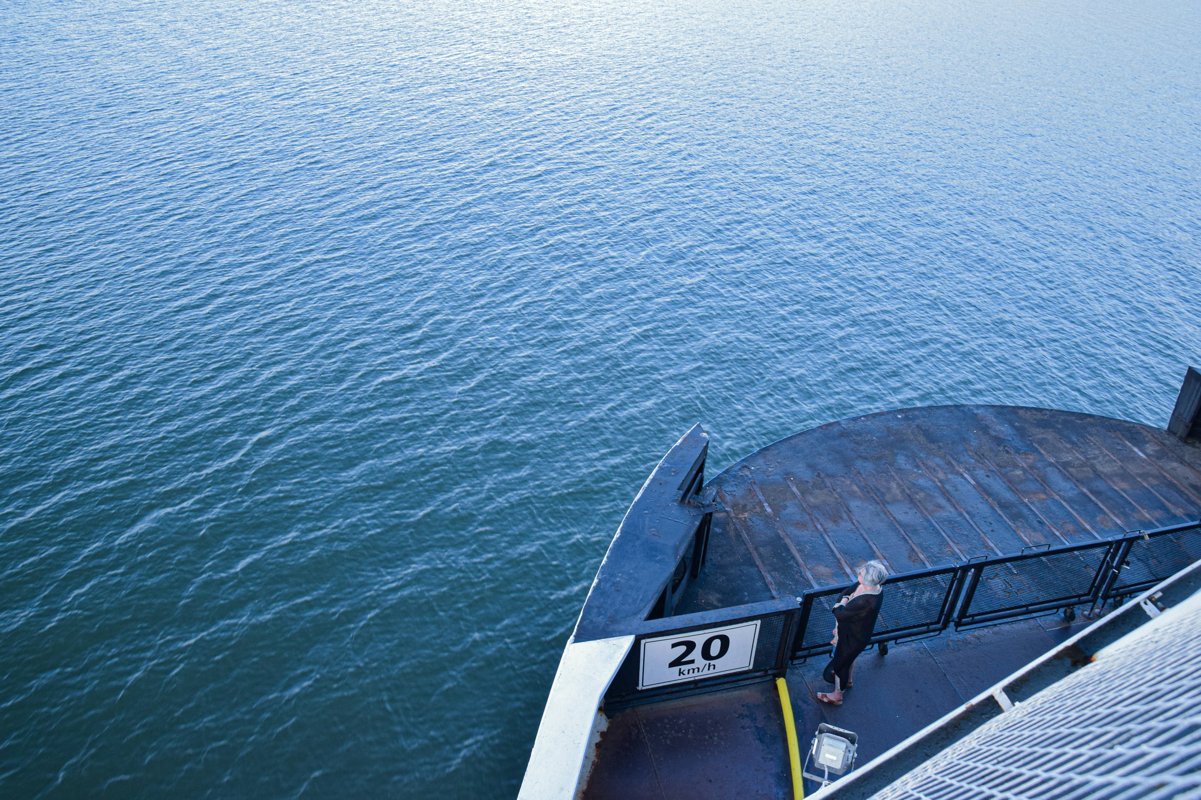 Image of a person standing on a dock with water surface visible dock marked with the number 20