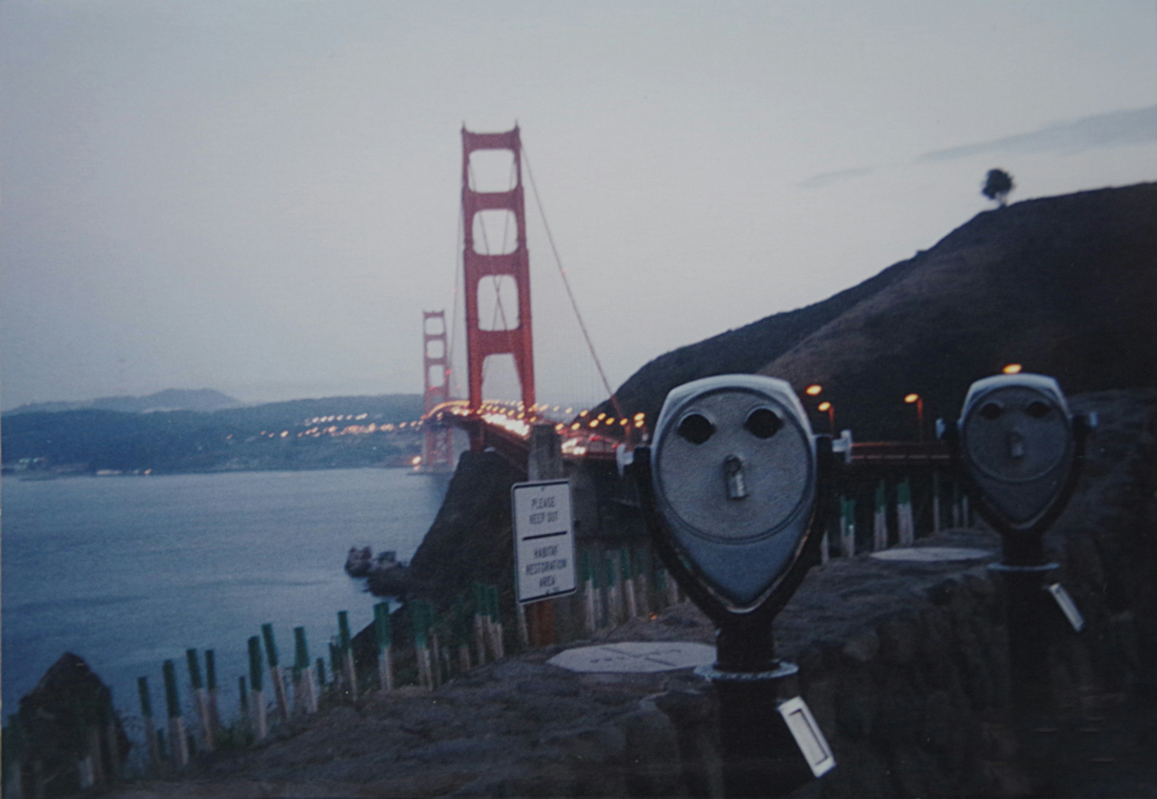 Night view of the Golden Gate Bridge with viewing binoculars