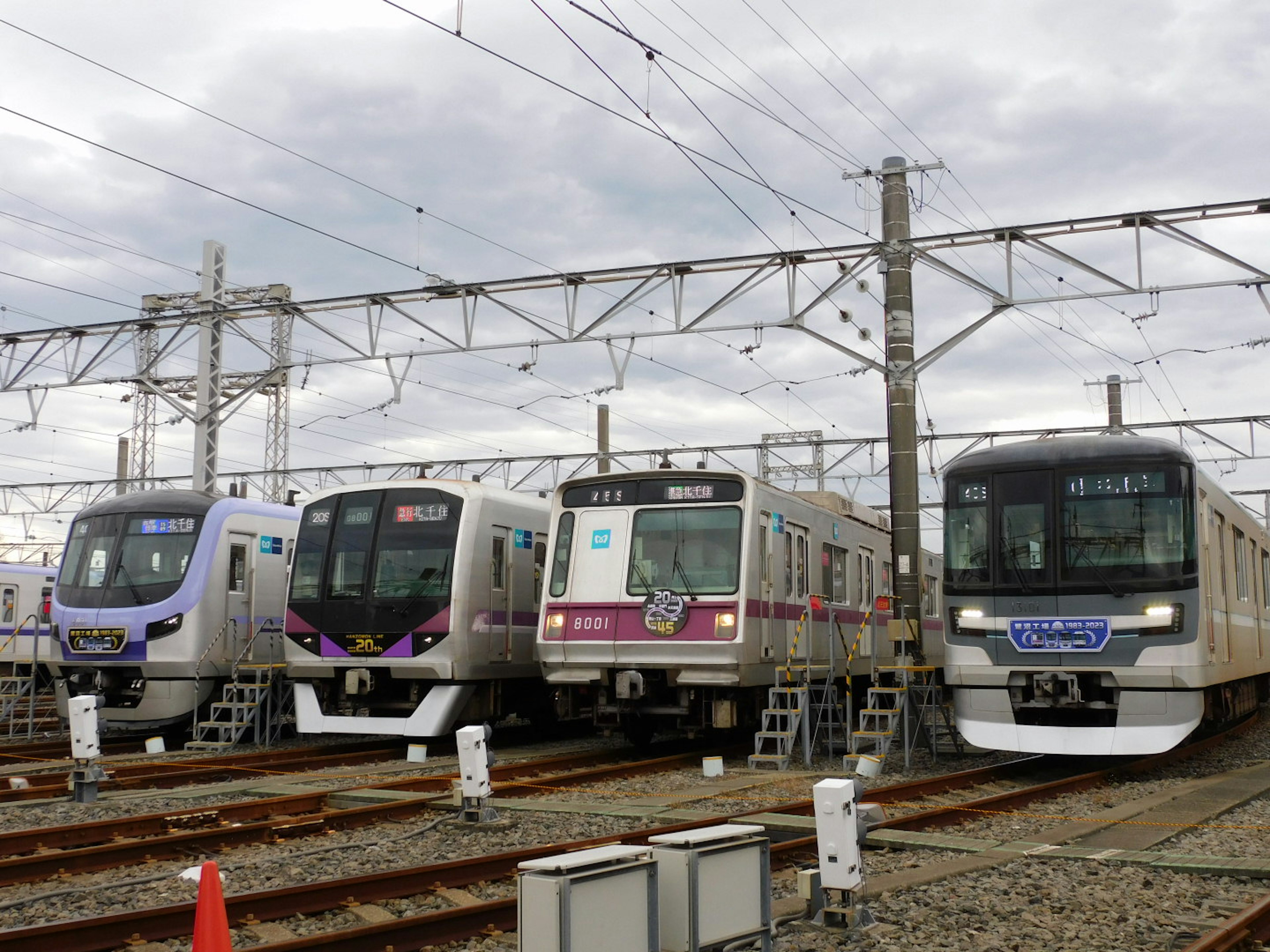 Four trains lined up on railway tracks