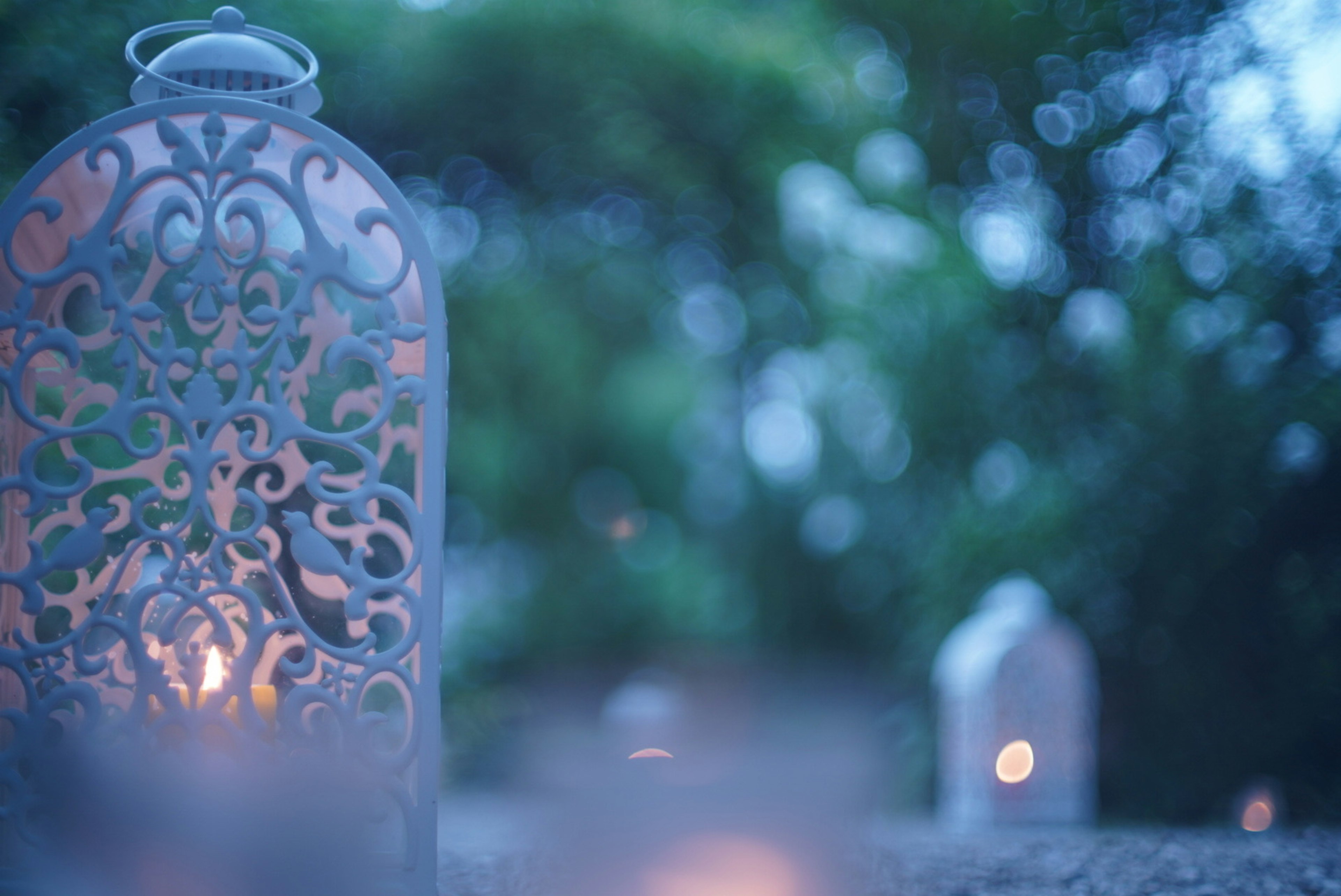 Decorative lanterns glowing in a blue background setting