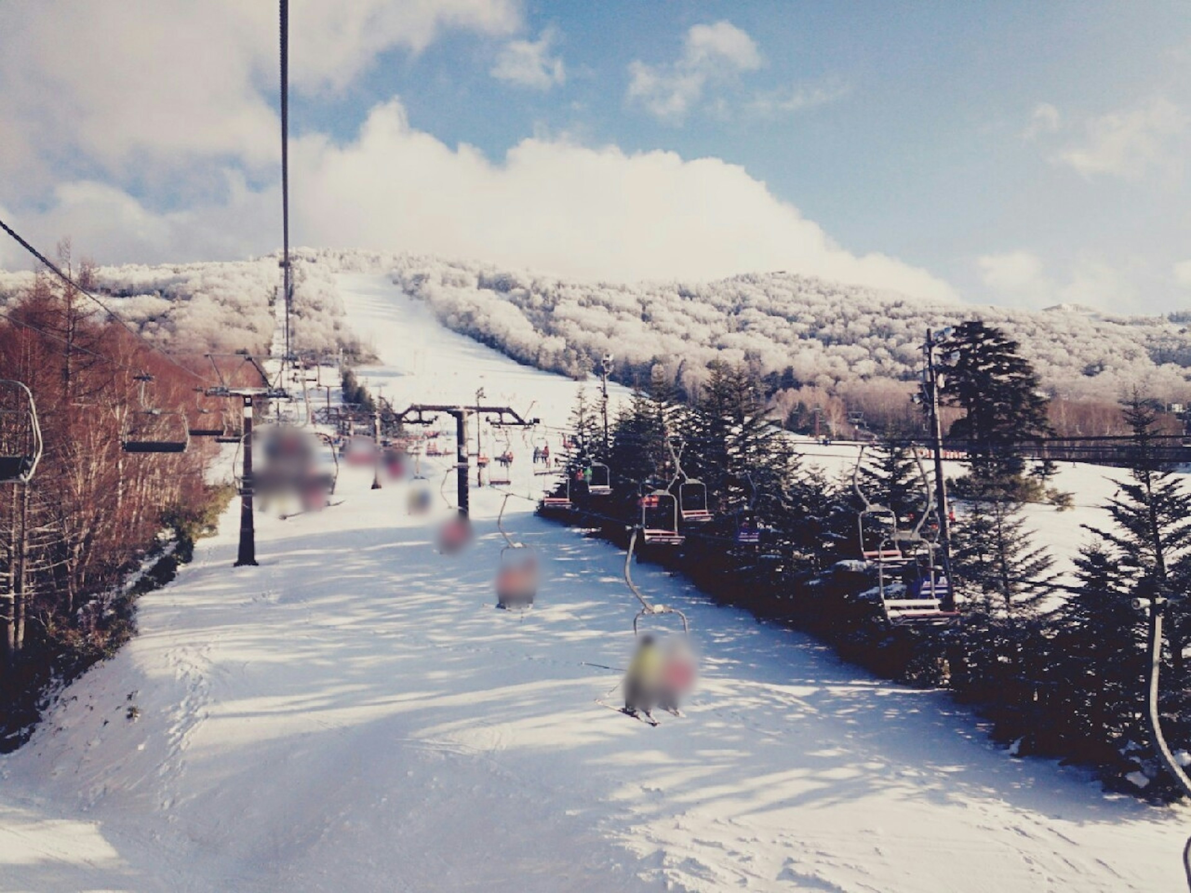 Snow-covered mountain landscape with ski lifts