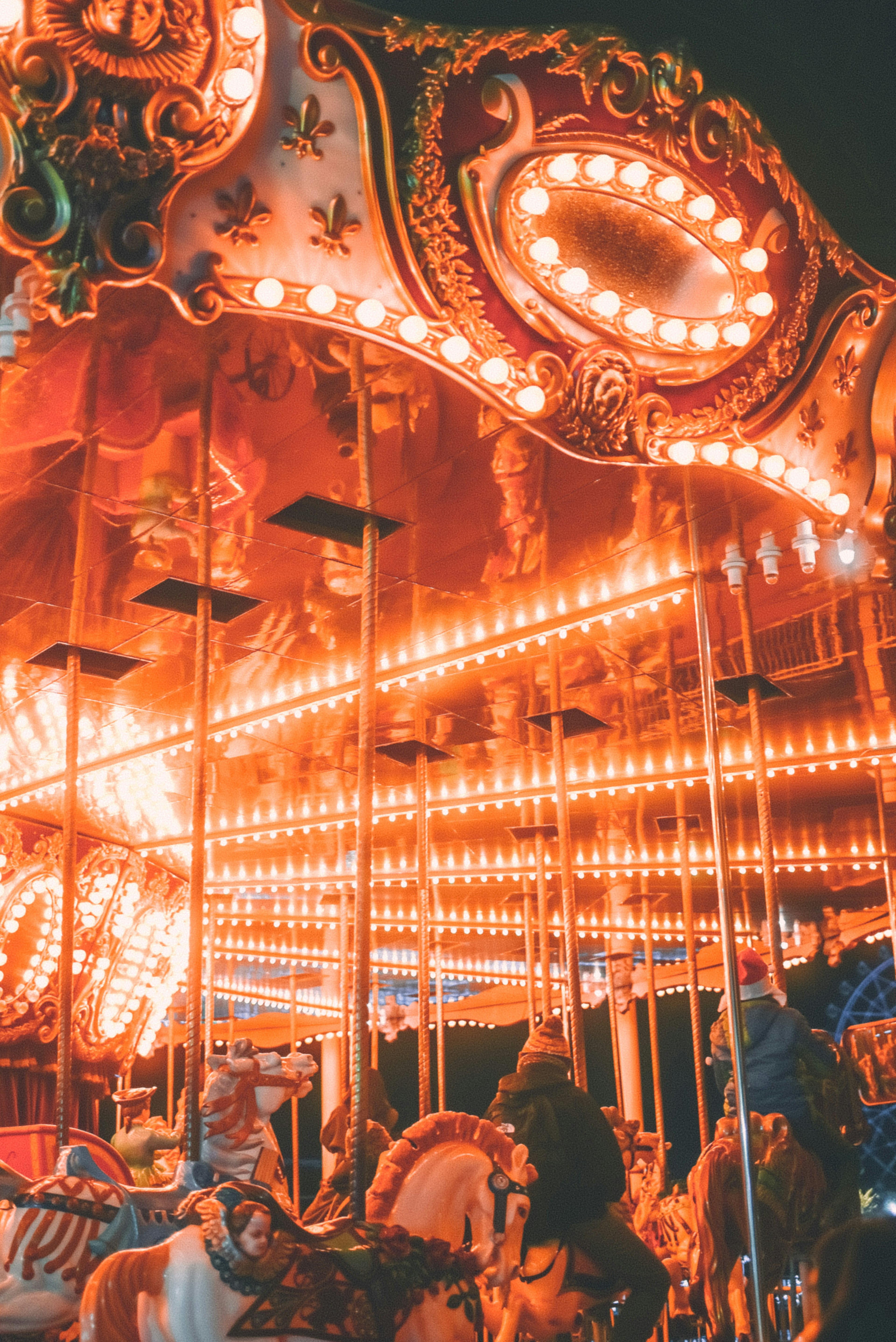 A carousel illuminated by bright lights at night