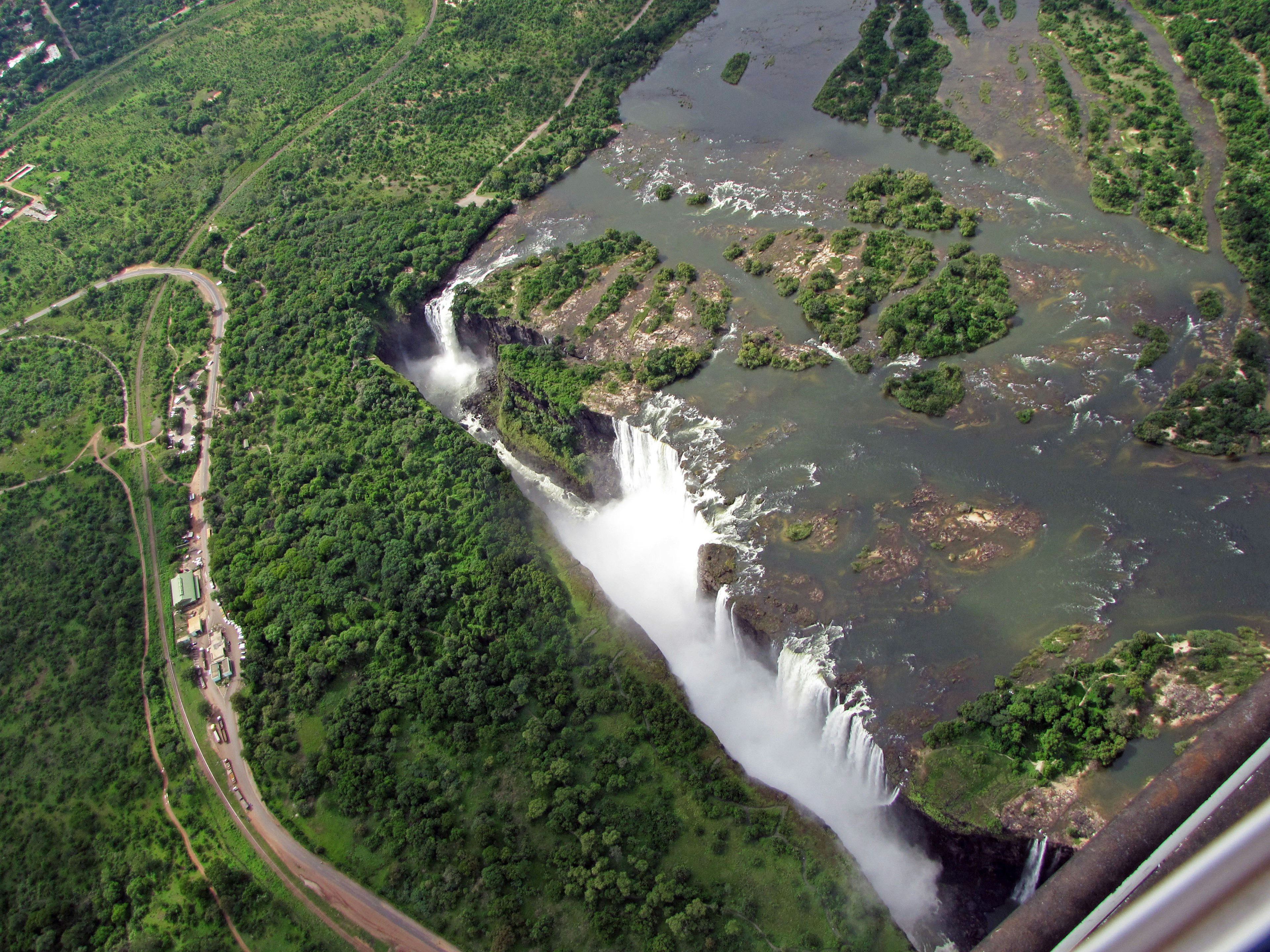 Aerial view of a waterfall surrounded by lush greenery