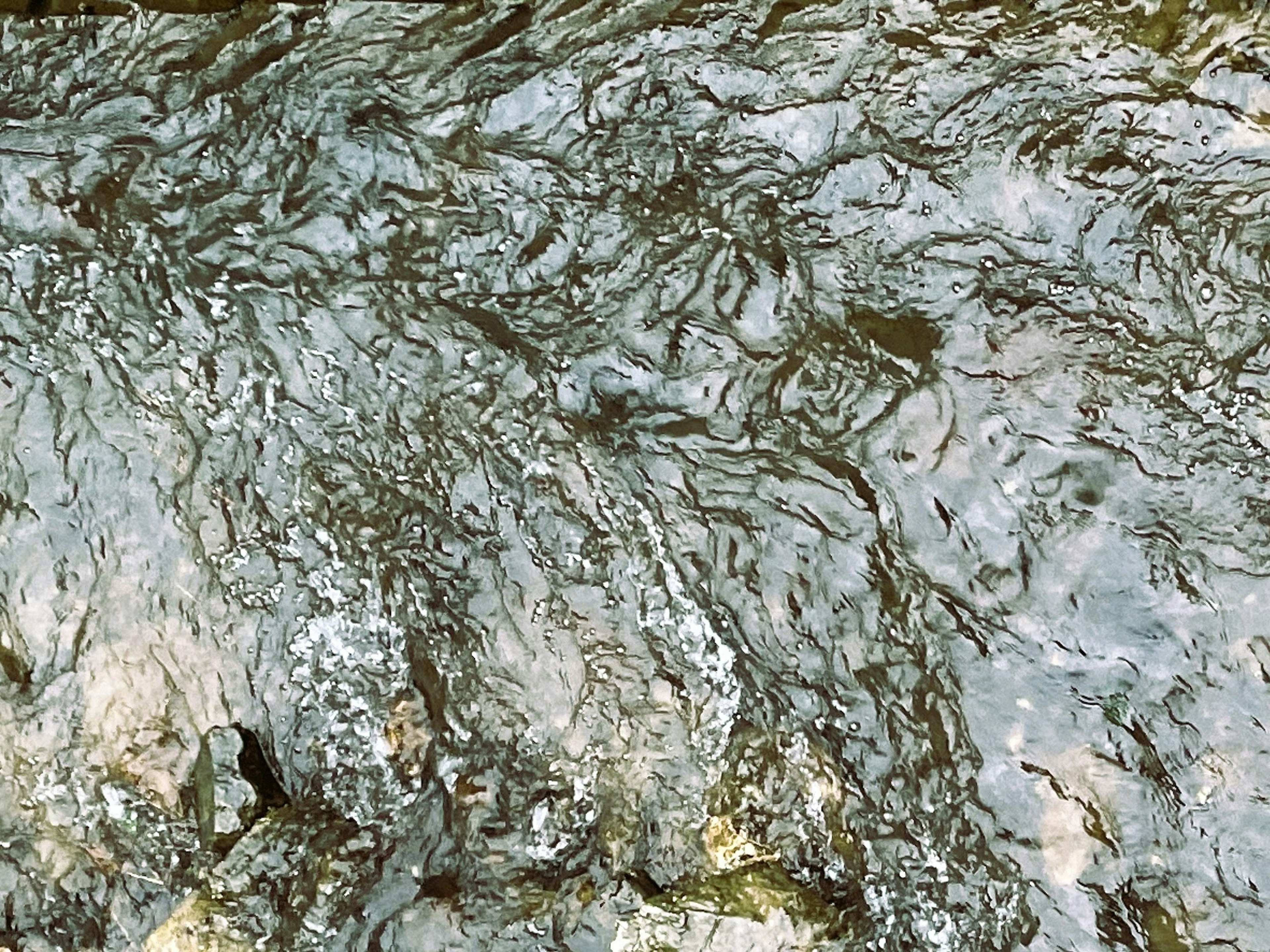 Detailed view of a rocky surface with flowing water