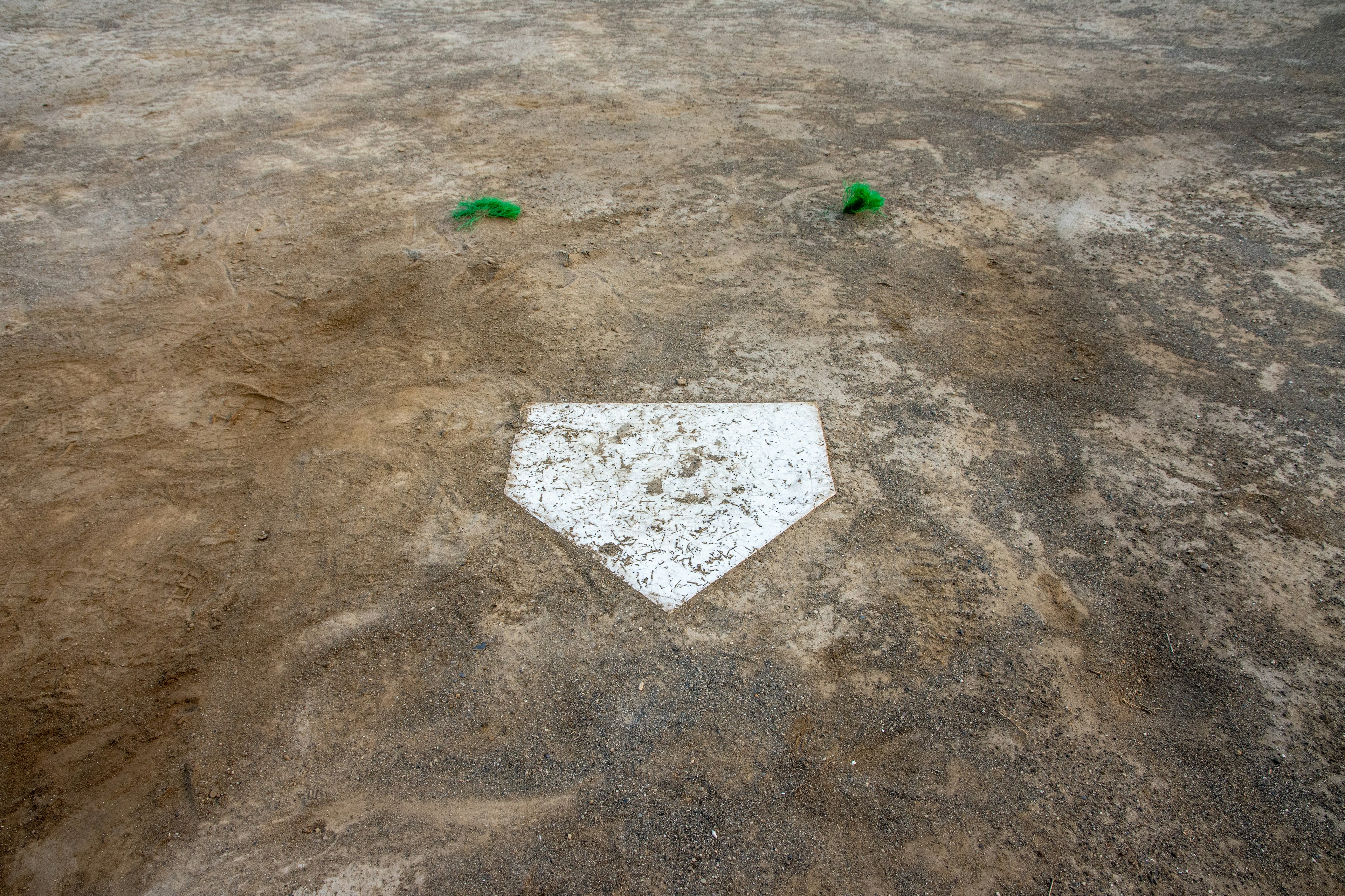 Baseball home plate with dirt field surrounding it