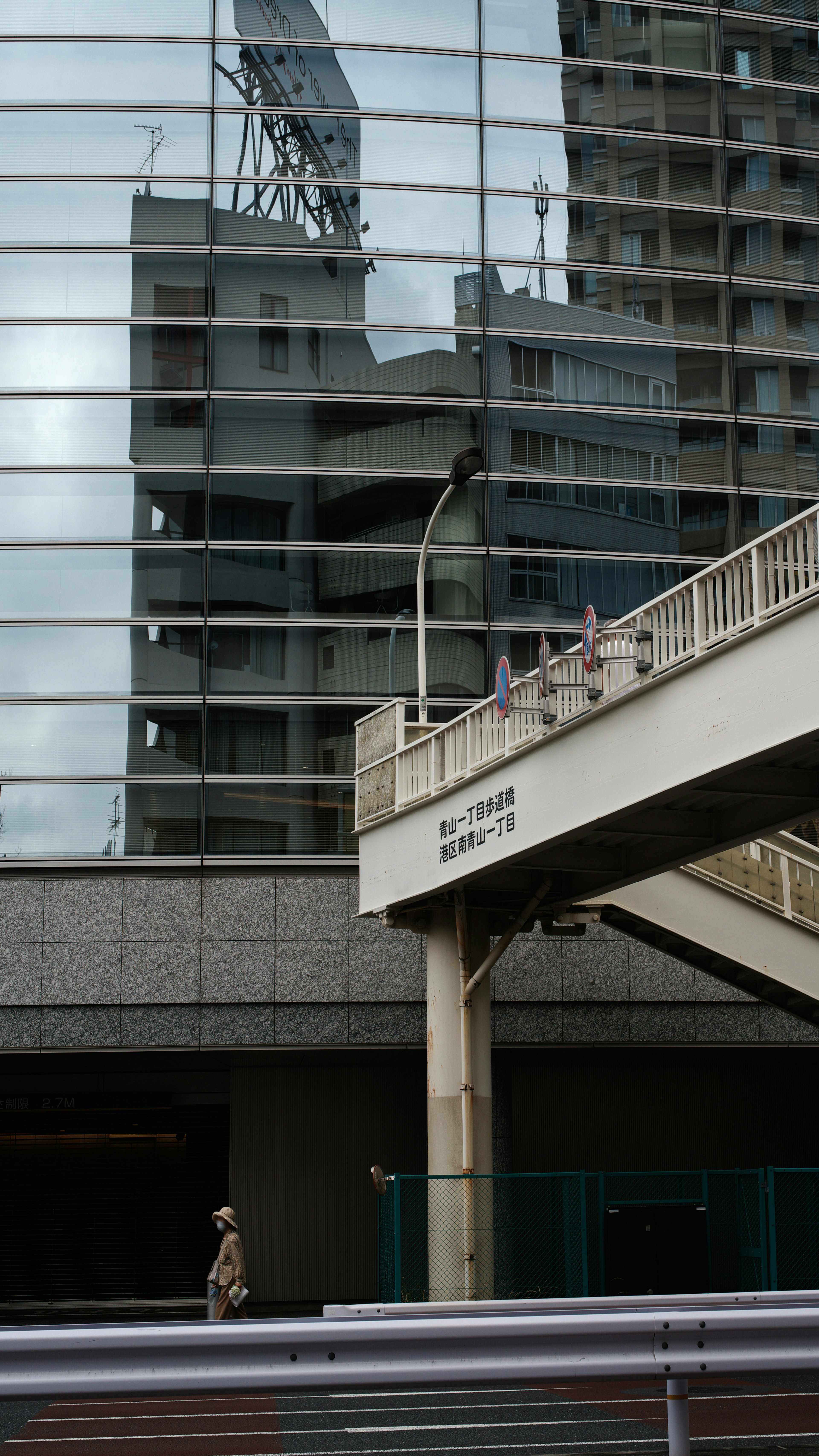 Urban scene with building reflections visible pedestrian bridge structure