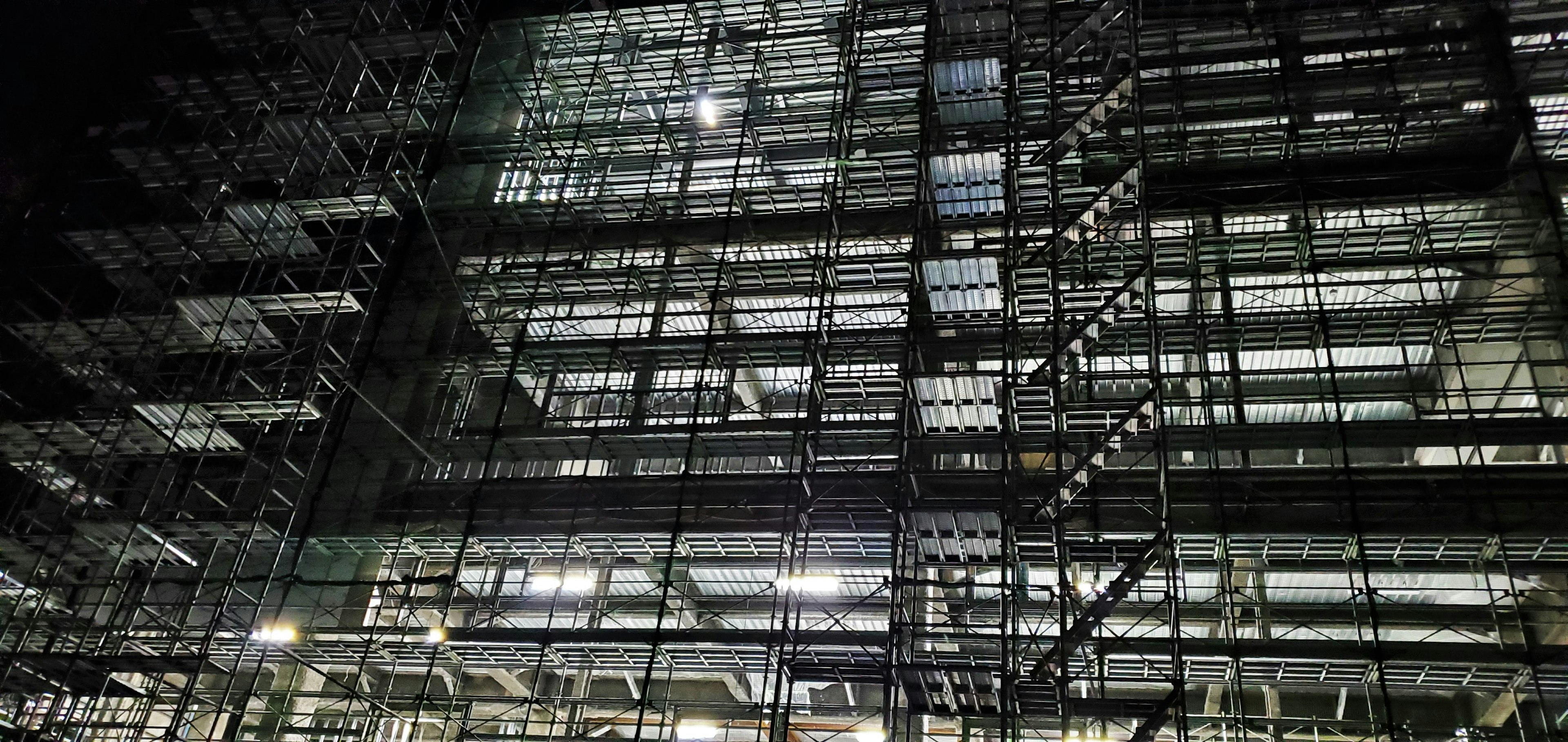 Nighttime view of a construction site structure with lighting