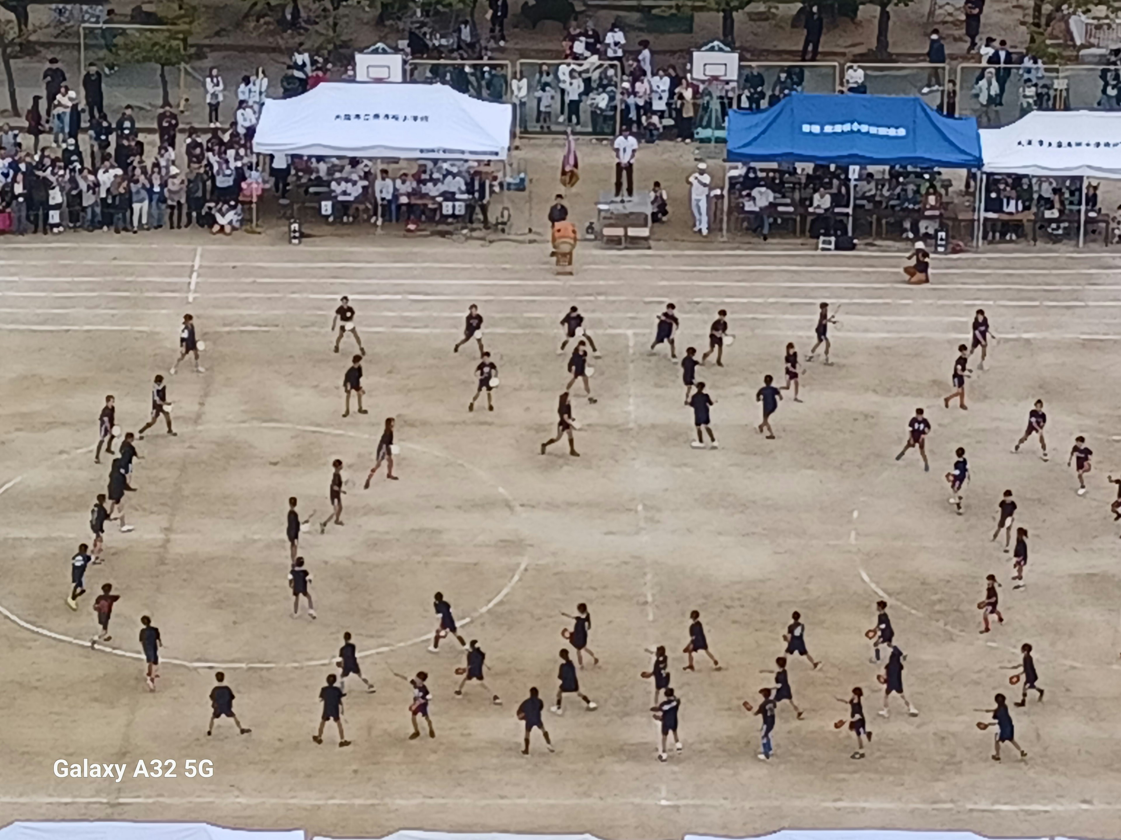 Students forming a large circle during a sports festival