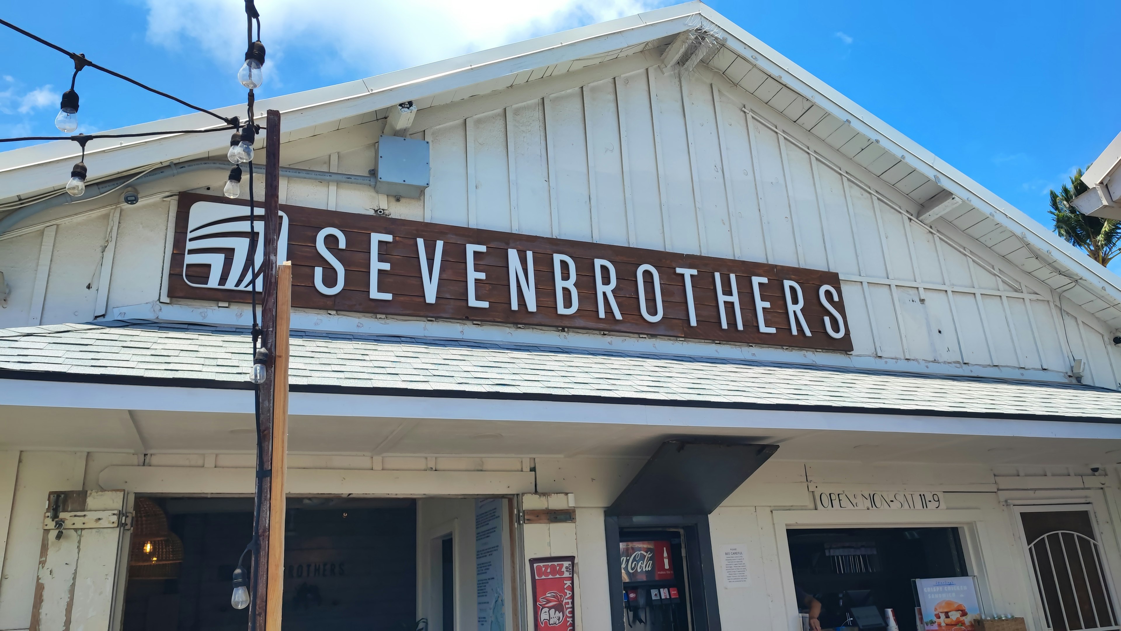 Exterior of Seven Brothers building with blue sky and white facade