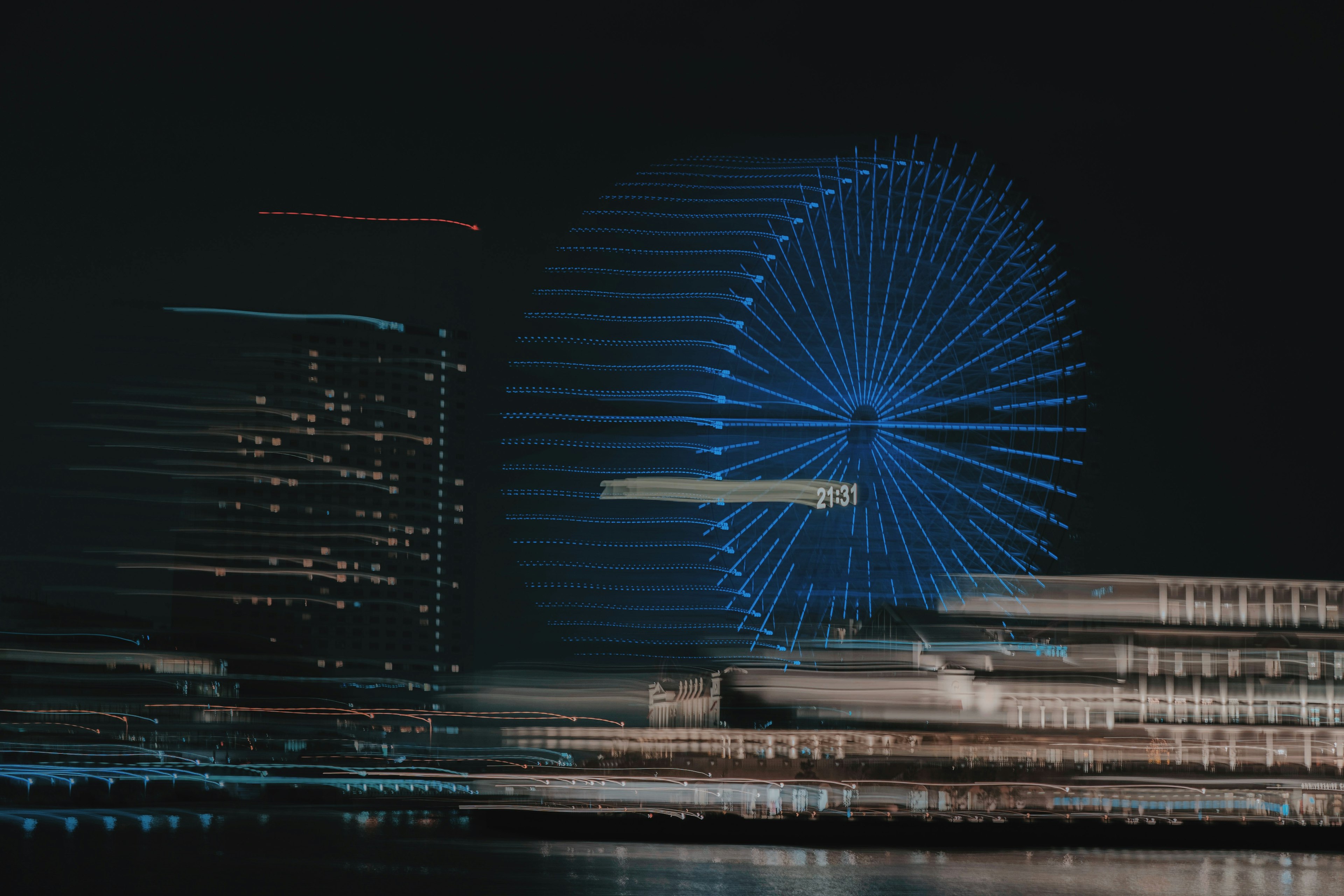 Image floue d'un paysage urbain nocturne avec une grande roue bleue