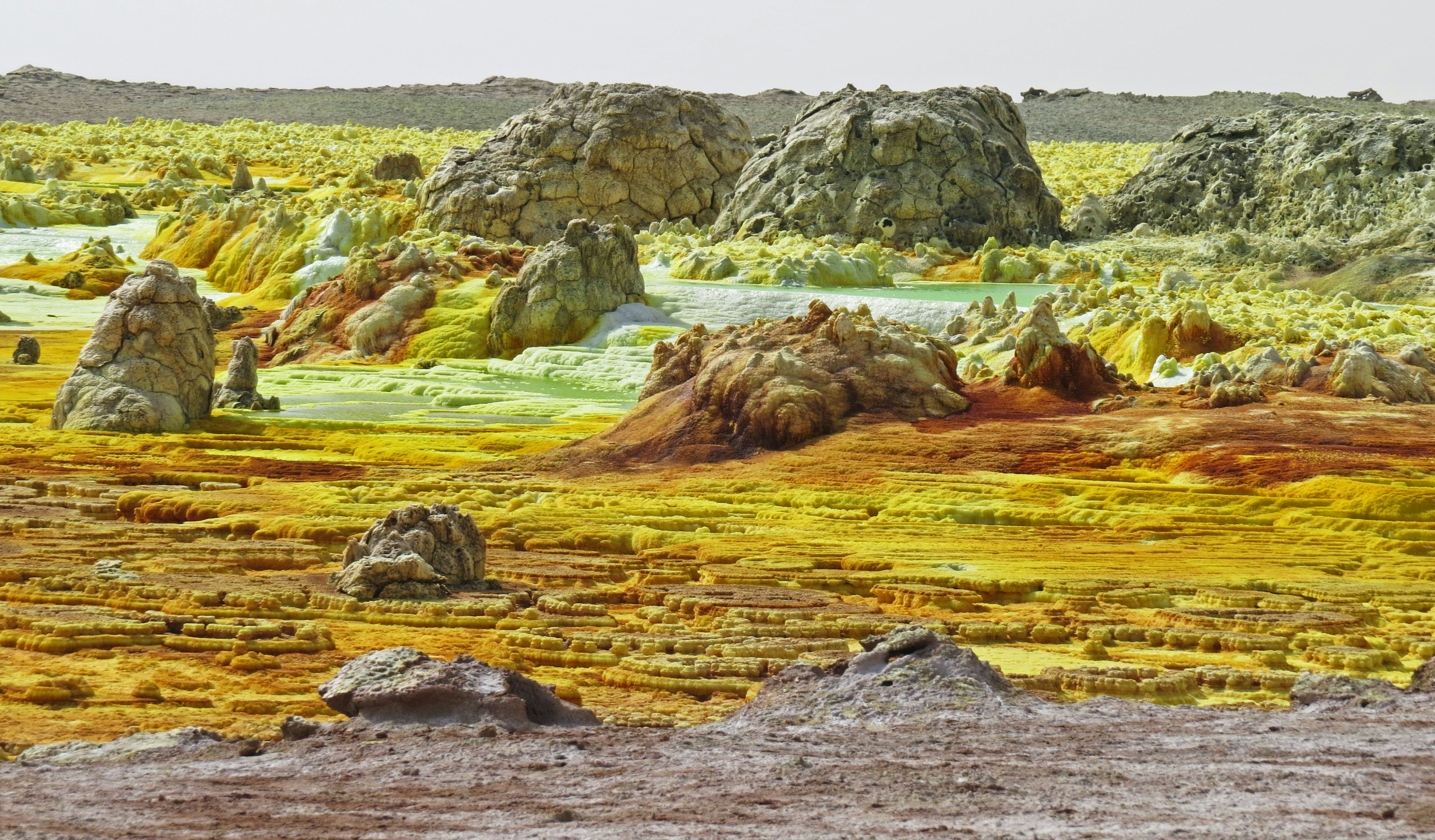 Colorful terrain landscape featuring yellow, green, and orange rocks and ground