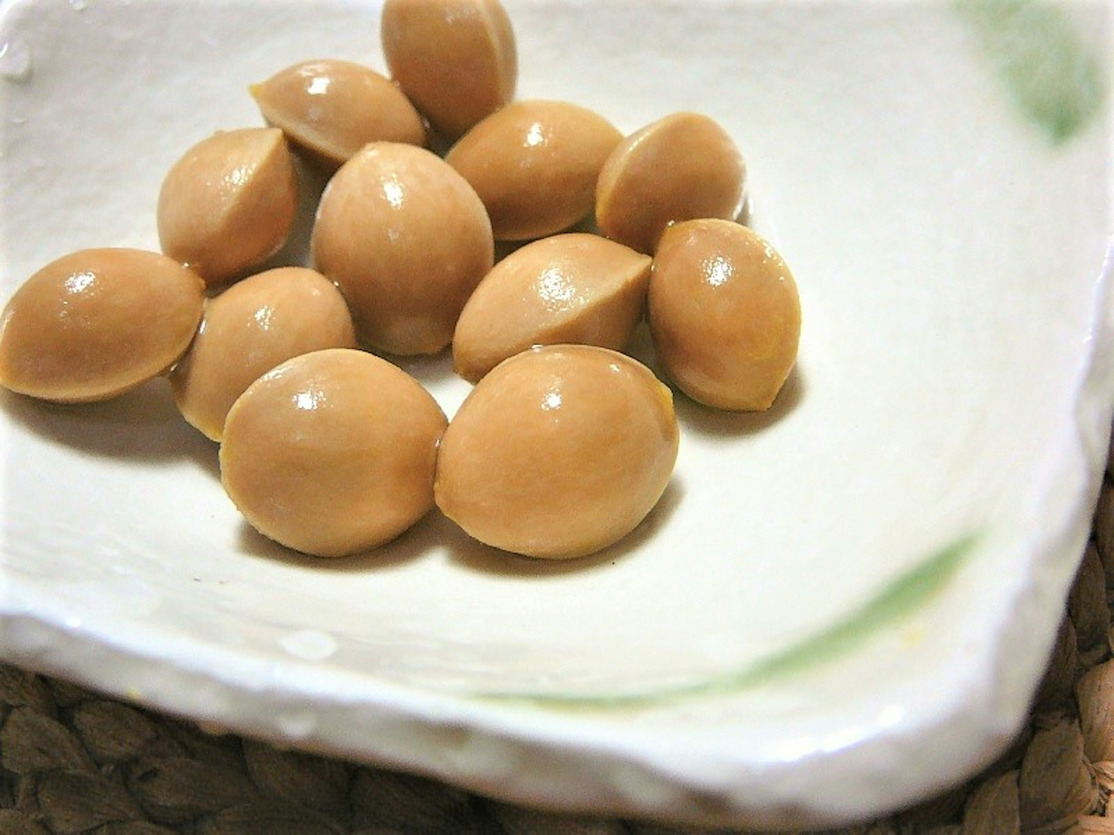 A plate with several light brown nuts arranged neatly